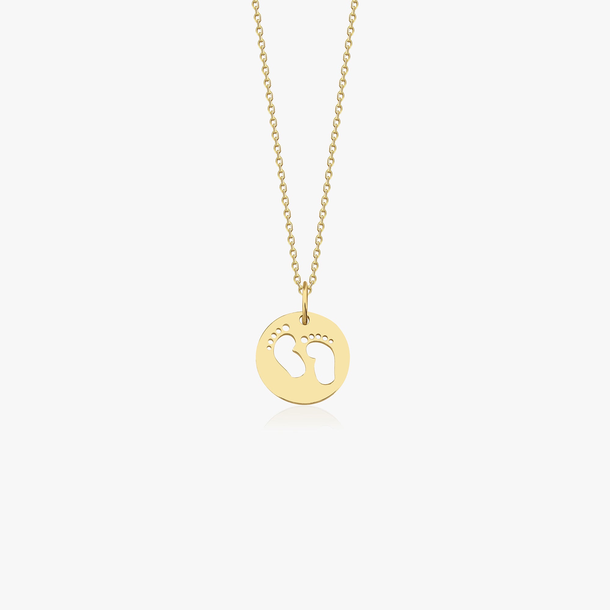 A 14k yellow gold baby foortprint necklace shown on a white background.