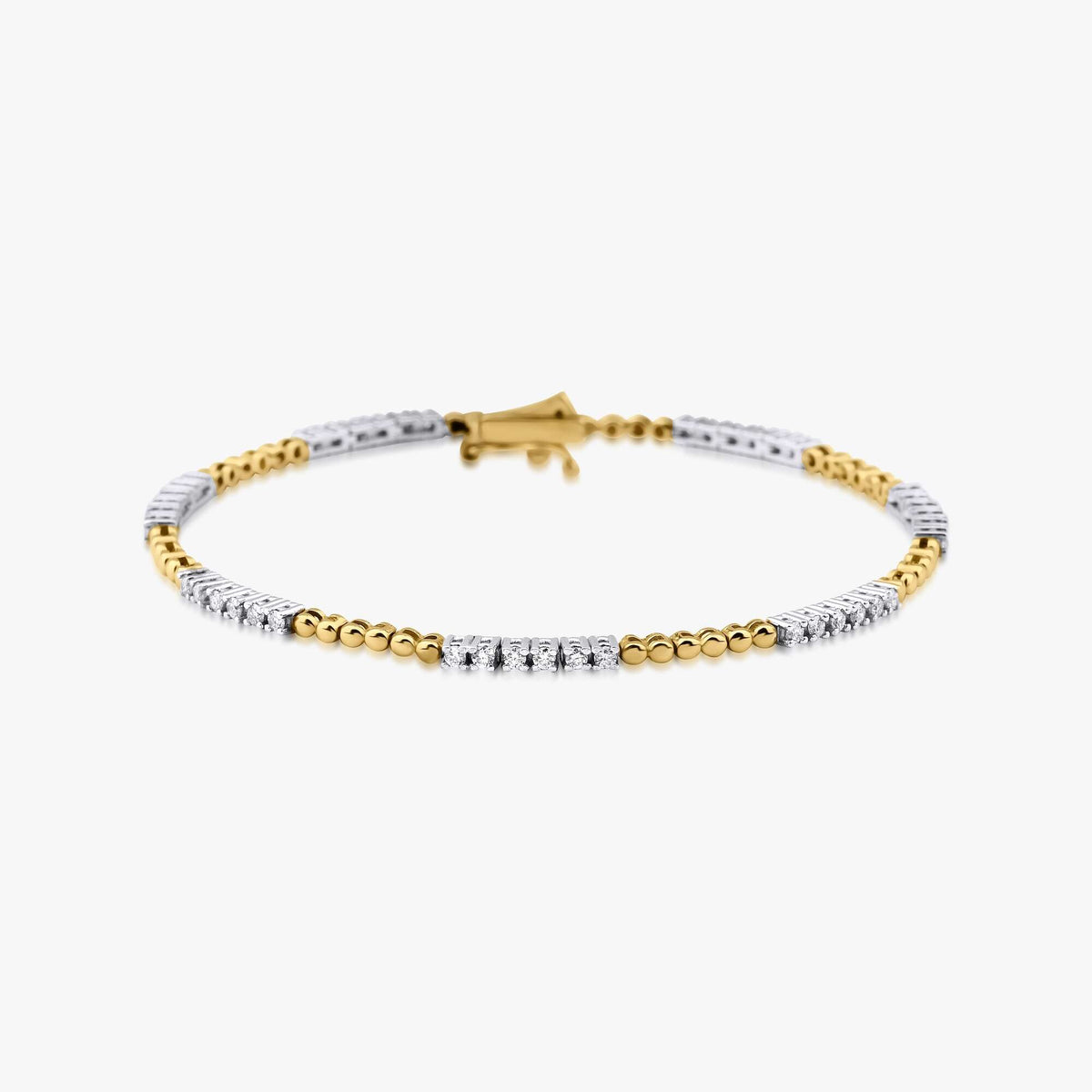 A dainty tennis bracelet made of 14K gold, featuring a solid gold band with hand-selected natural diamonds set within.