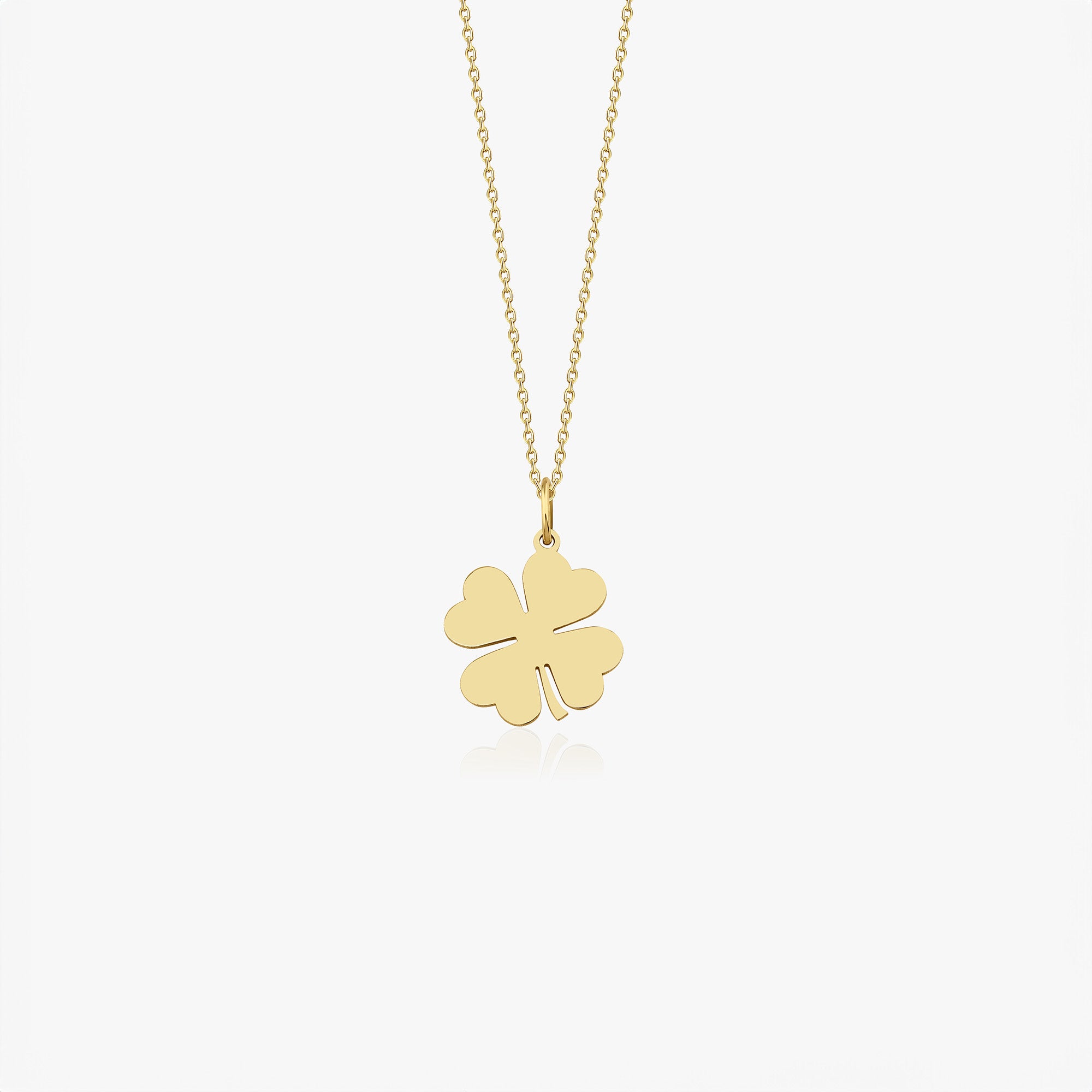A 14k yellow gold four-leaf clover necklace on a white background