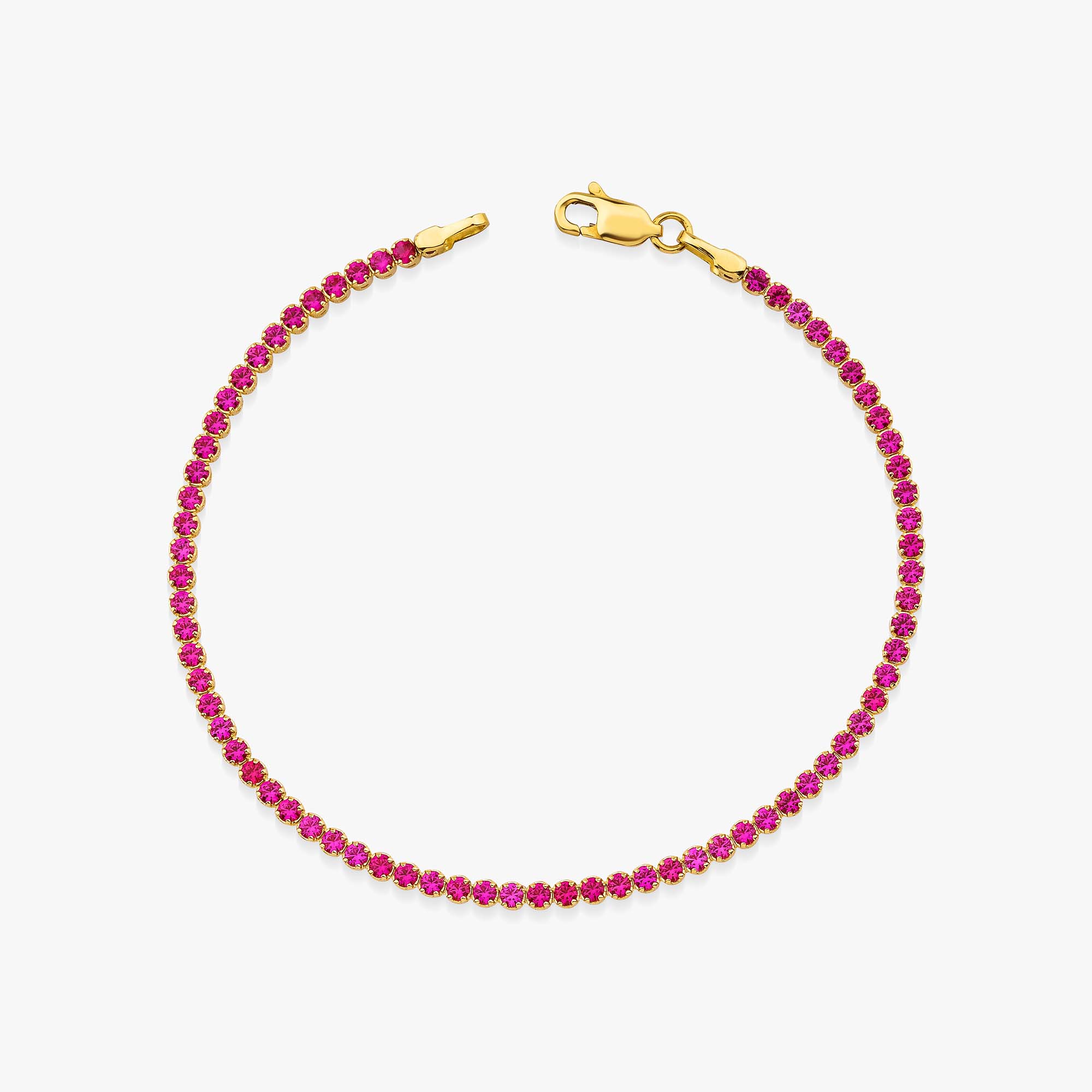 A created ruby tennis bracelet in 14K yellow gold with a width of 2.1 mm, featuring a series of red gemstones.