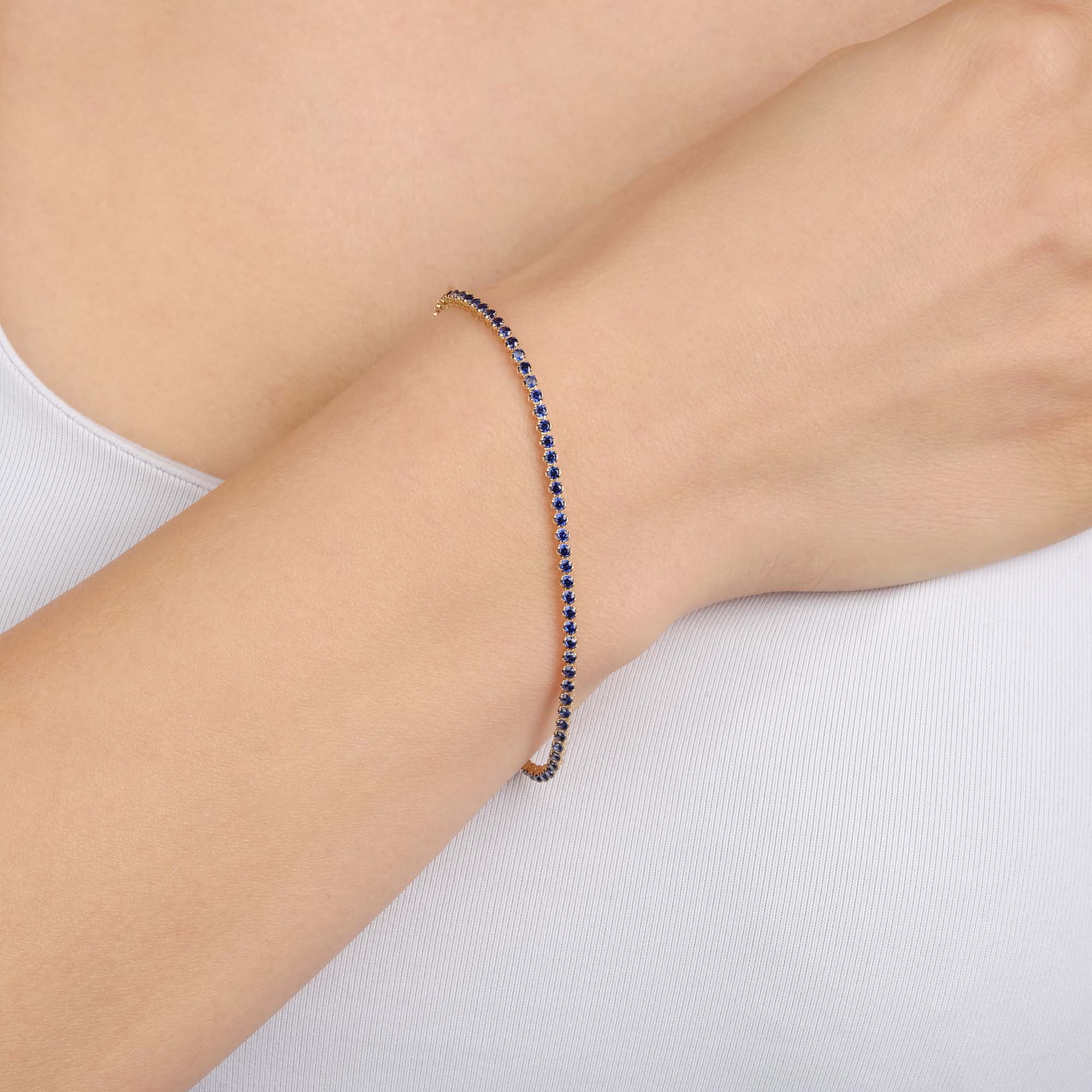 a model wearing a thin created sapphire bracelet