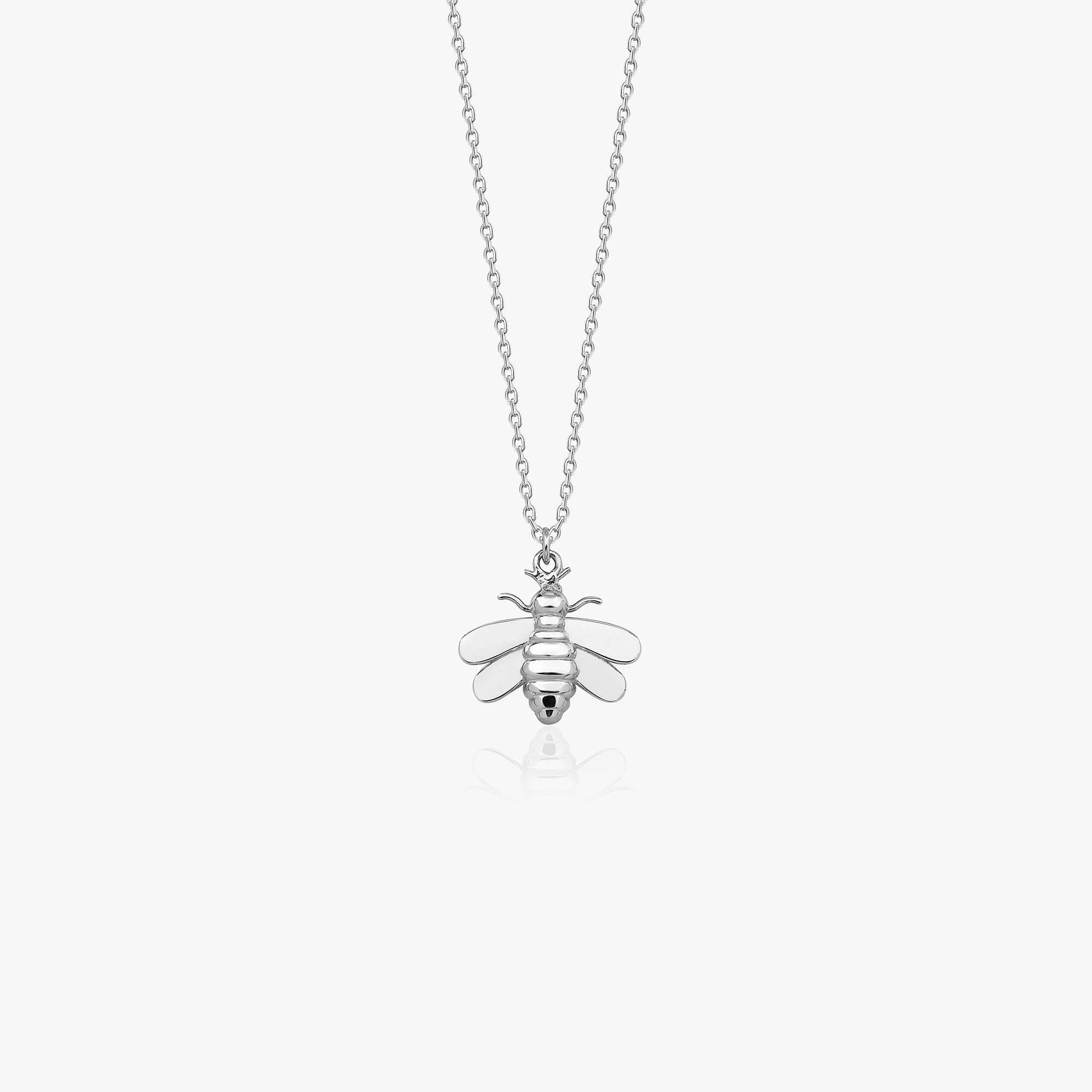 A 14k white gold bee necklace on a white background