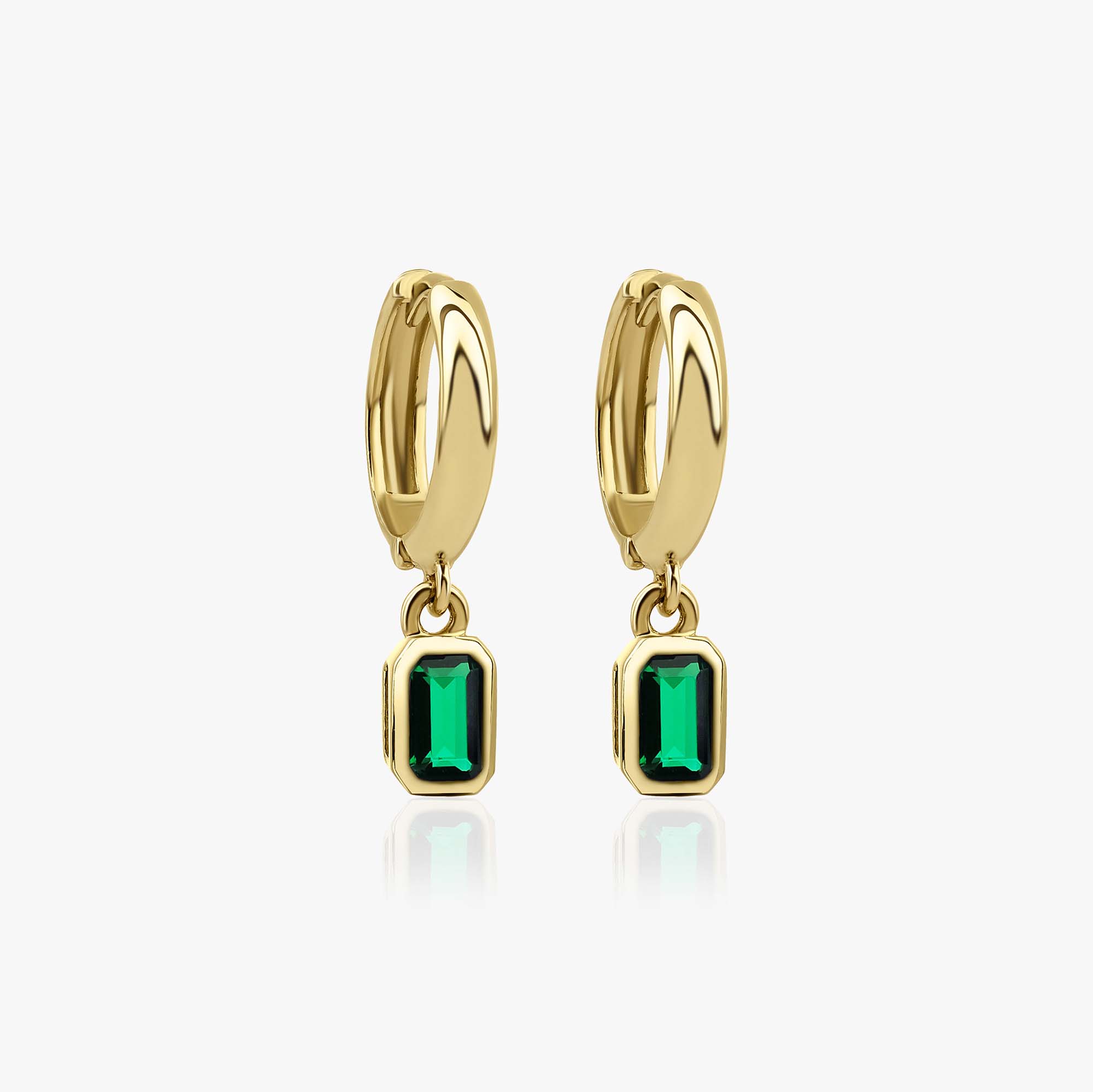 14k yellow hoop earrings with green gemstones on a white background
