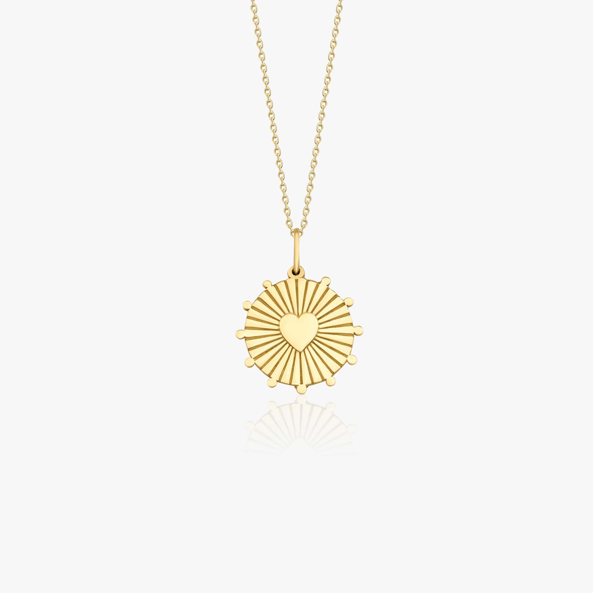 A 14k yellow gold heartburst coin pendant necklace shown on a white background.