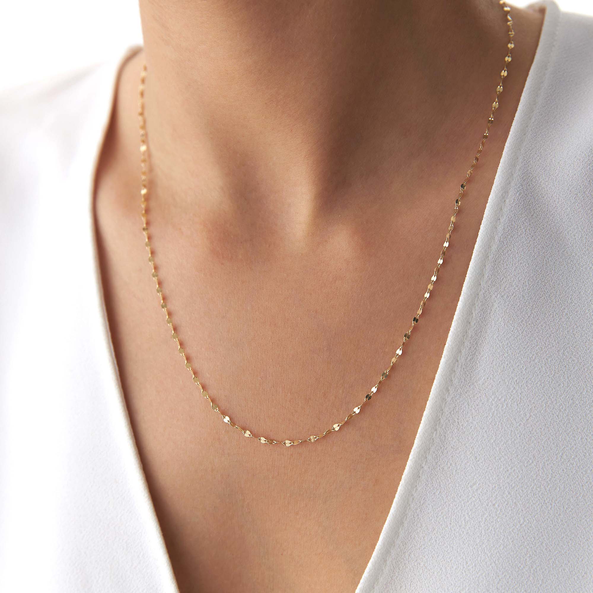 A model wearing a thin italian sparkle chain.