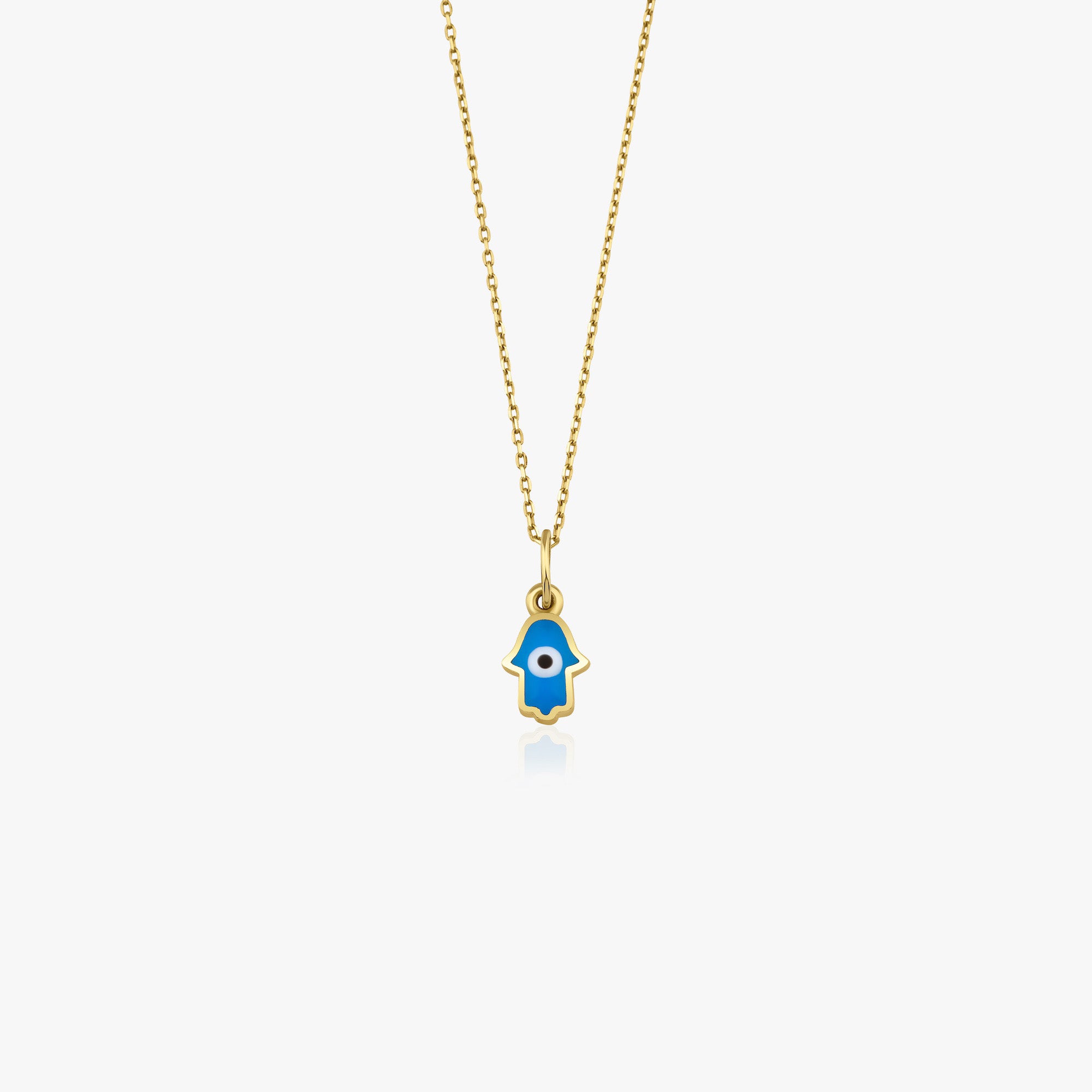 A 14k yellow gold tiny hamsa hand necklace with an evil eye center shown on a white background.