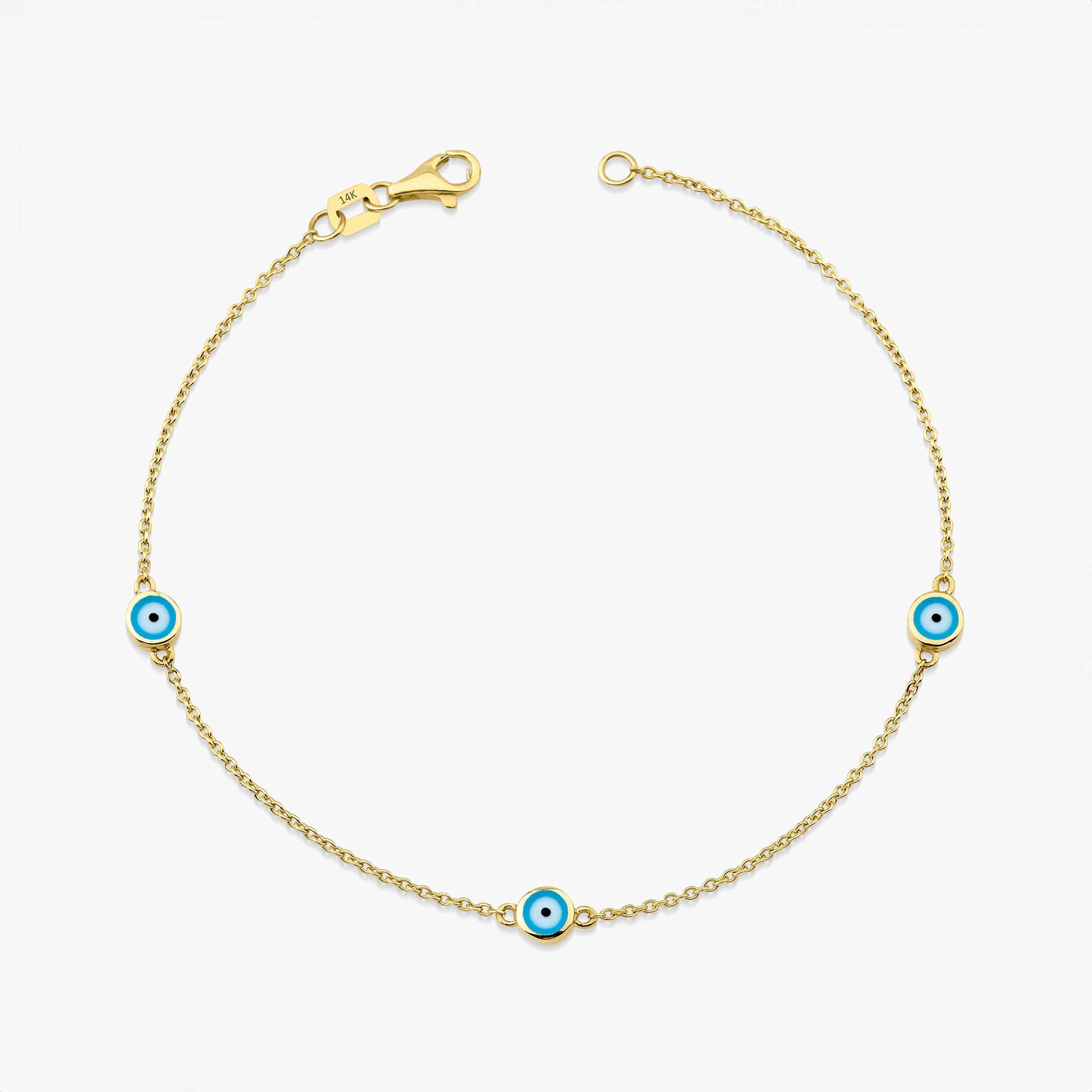 A 14K yellow gold bracelet with three ocean blue enamel evil eyes, designed for daily wear.