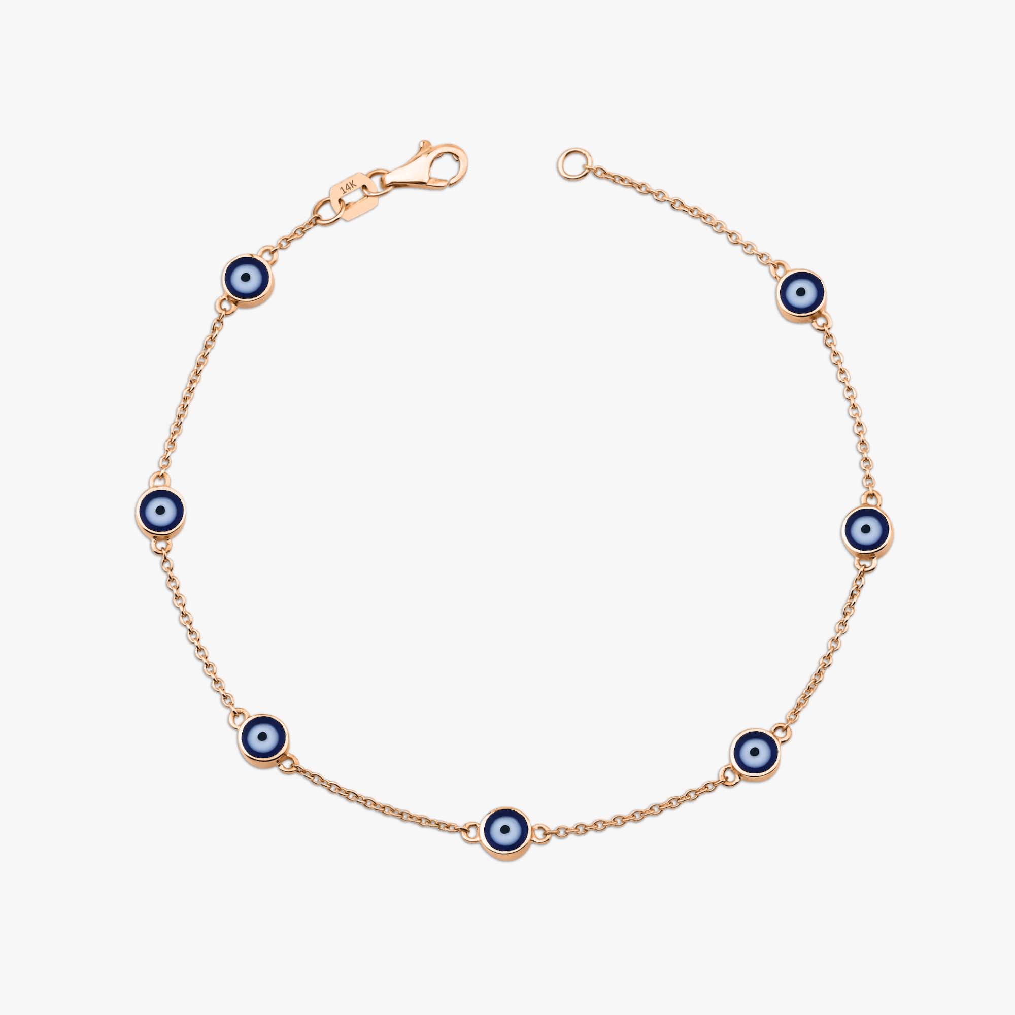 14k rose gold navy blue evil eye bracelet with 7 evil eyes shown on a white background