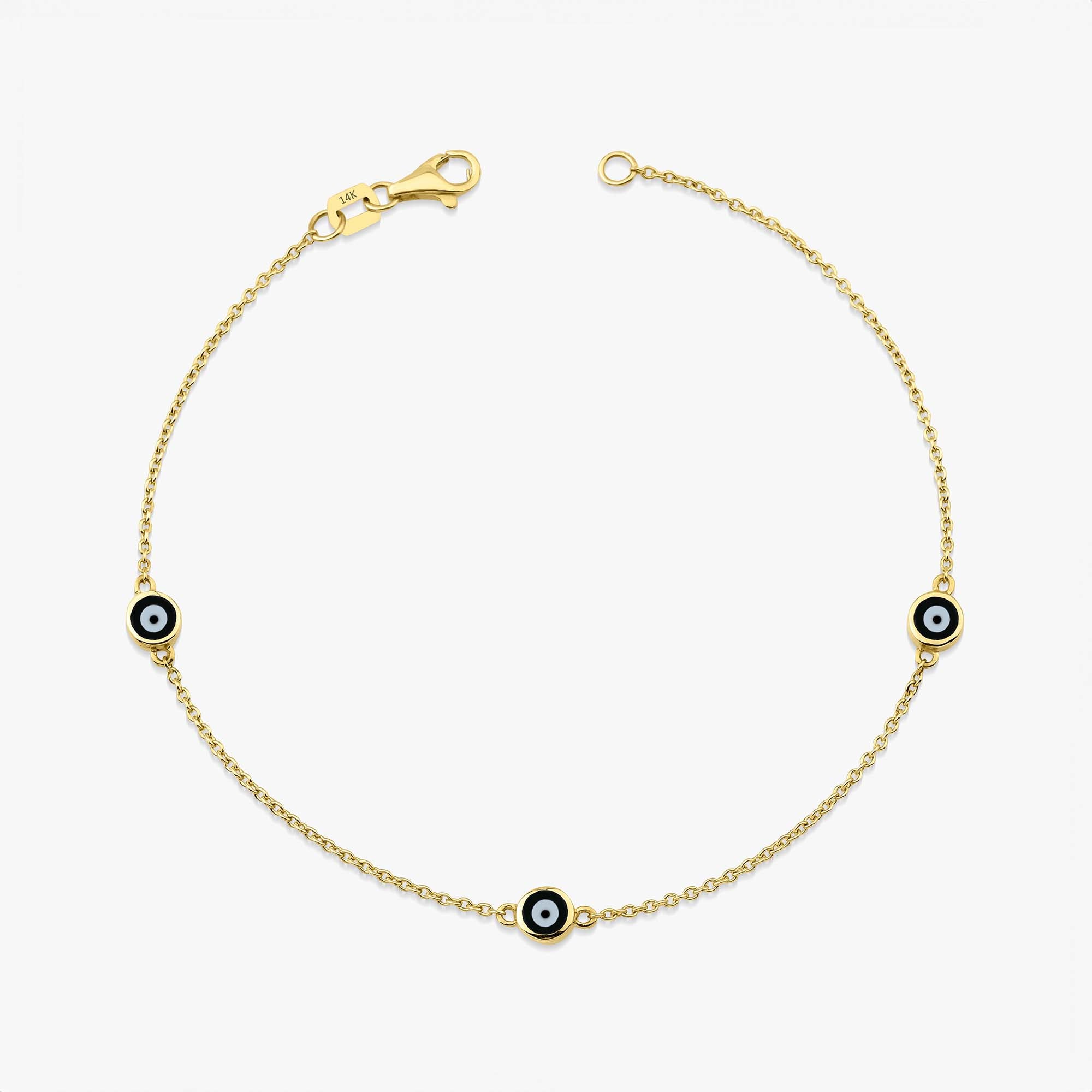 14 karat yellow gold three black evil eye bracelet with lobster clasp on a white background
