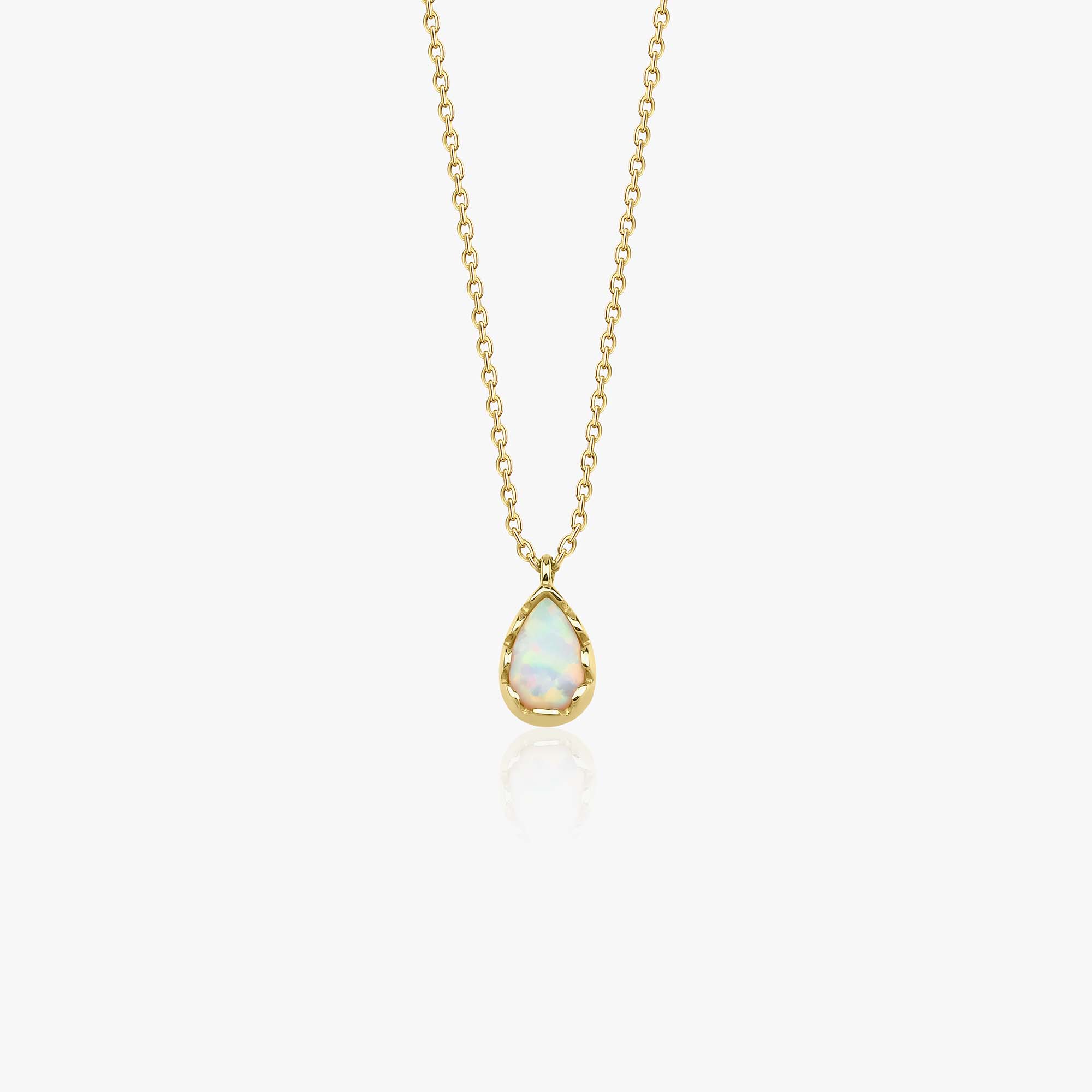 A 14k yellow gold minimal raindrop shaped lab opal pendant necklace shown on a white background.