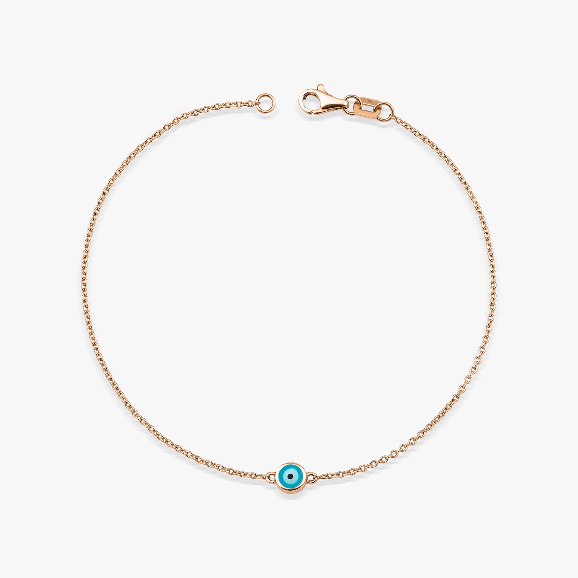 14 karat rose gold bracelet with an ocean blue evil eye charm on a white background