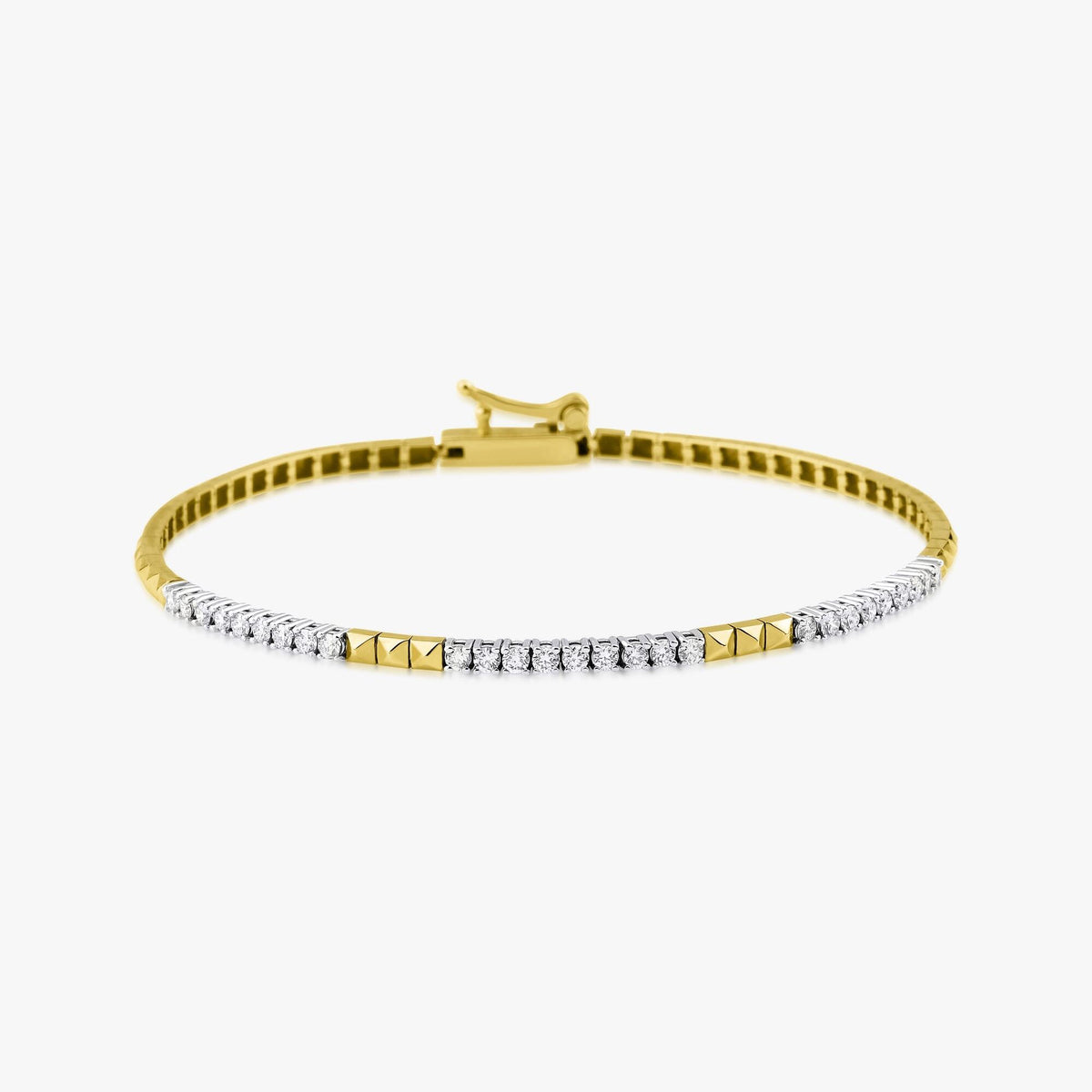 A 14K gold diamond spike bracelet with a solid pattern, featuring a series of round diamonds set in the gold spikes.