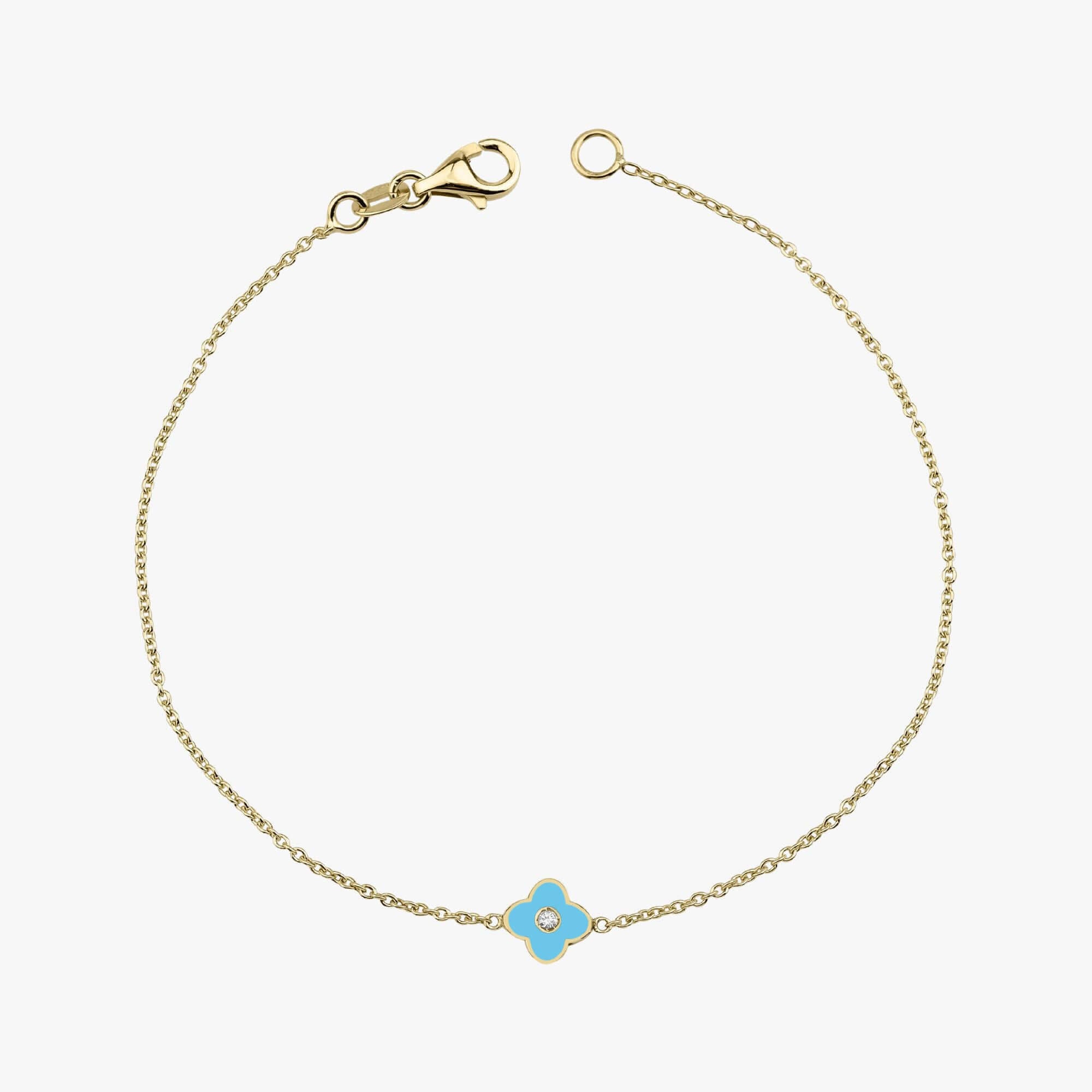 A double-sided 14K gold bracelet with turquoise enamel clover accents and two central diamonds on each side.