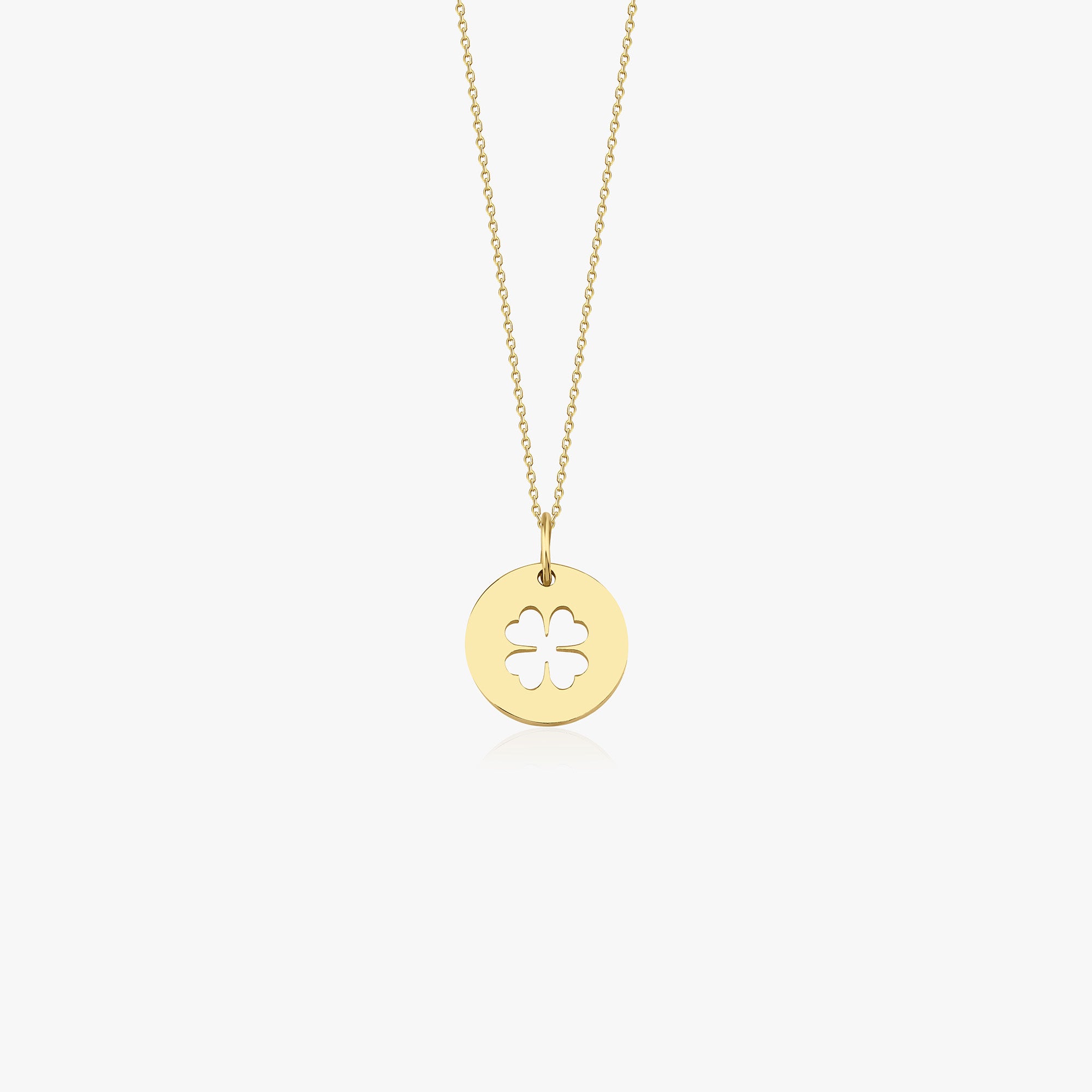 Gold necklace with a clover-shaped pendant on a white background