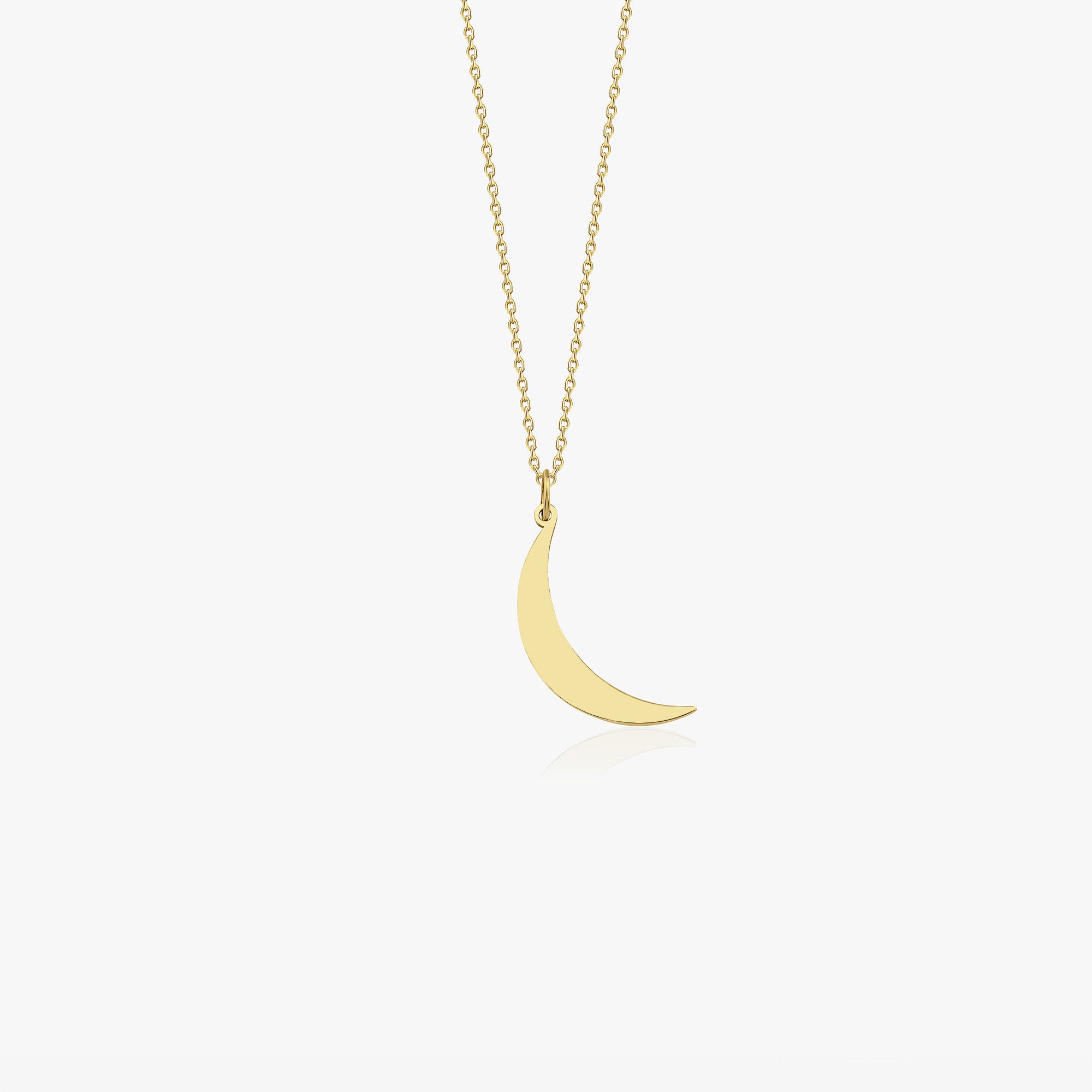 14K yellow gold crescent moon necklace on a white background