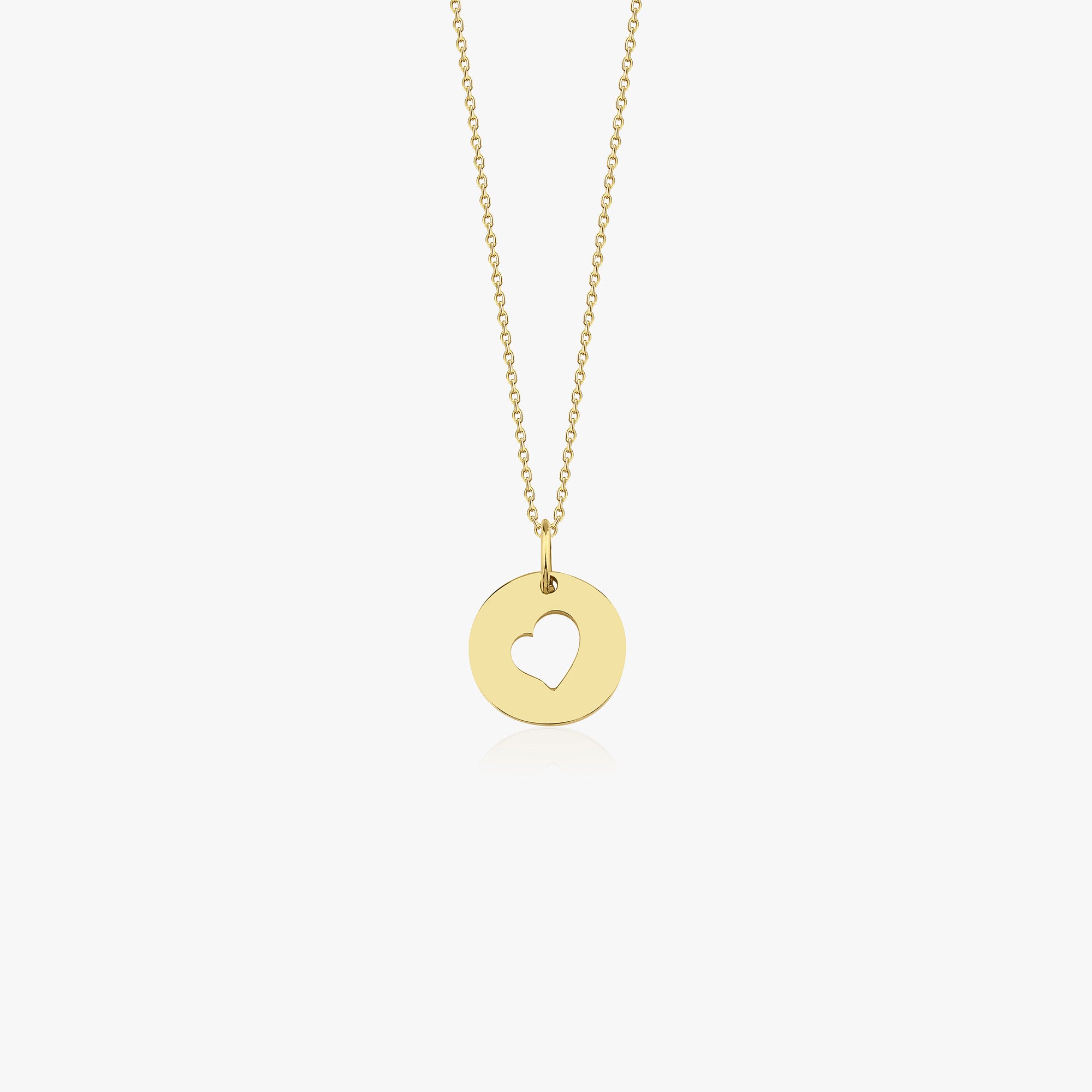 A 14k yellow gold necklace with a heart cutout pendant center on a white background