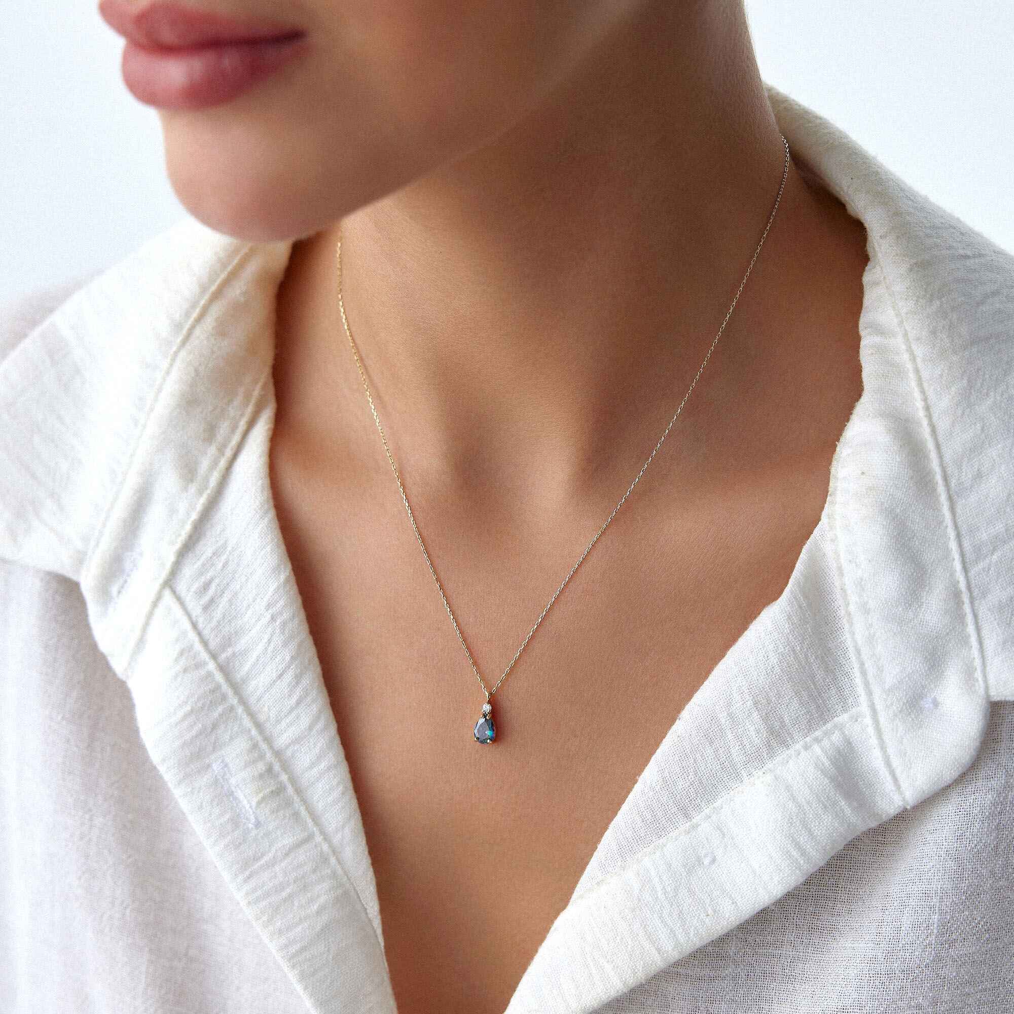 An image of a model wearing a mystic topaz necklace