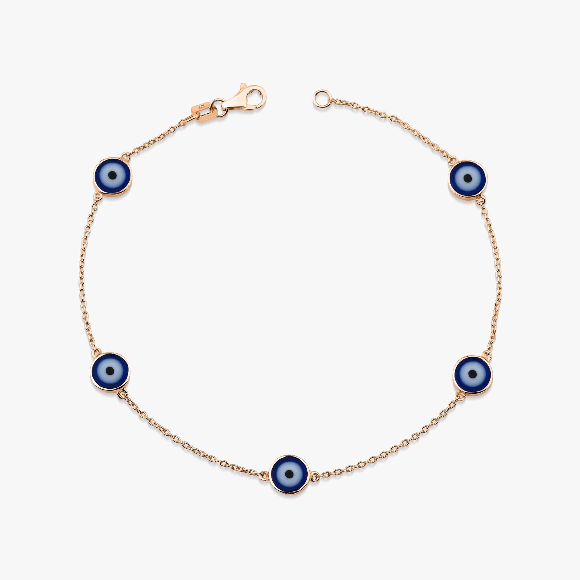 14k rose gold evil eye bracelet with 5 navy blue evil eye charms on a white background