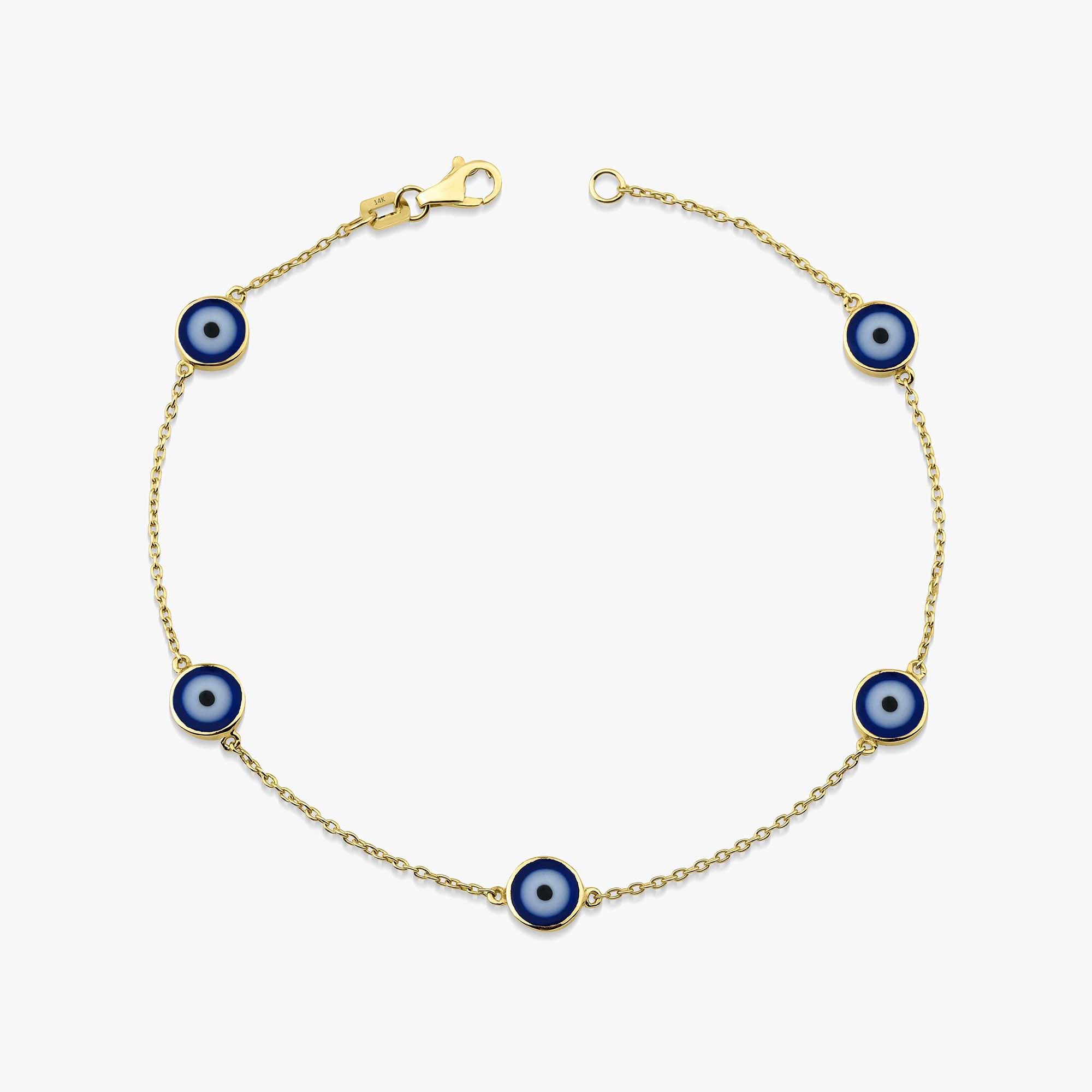 14k yellow gold evil eye bracelet with 5 navy blue evil eye charms on a white background