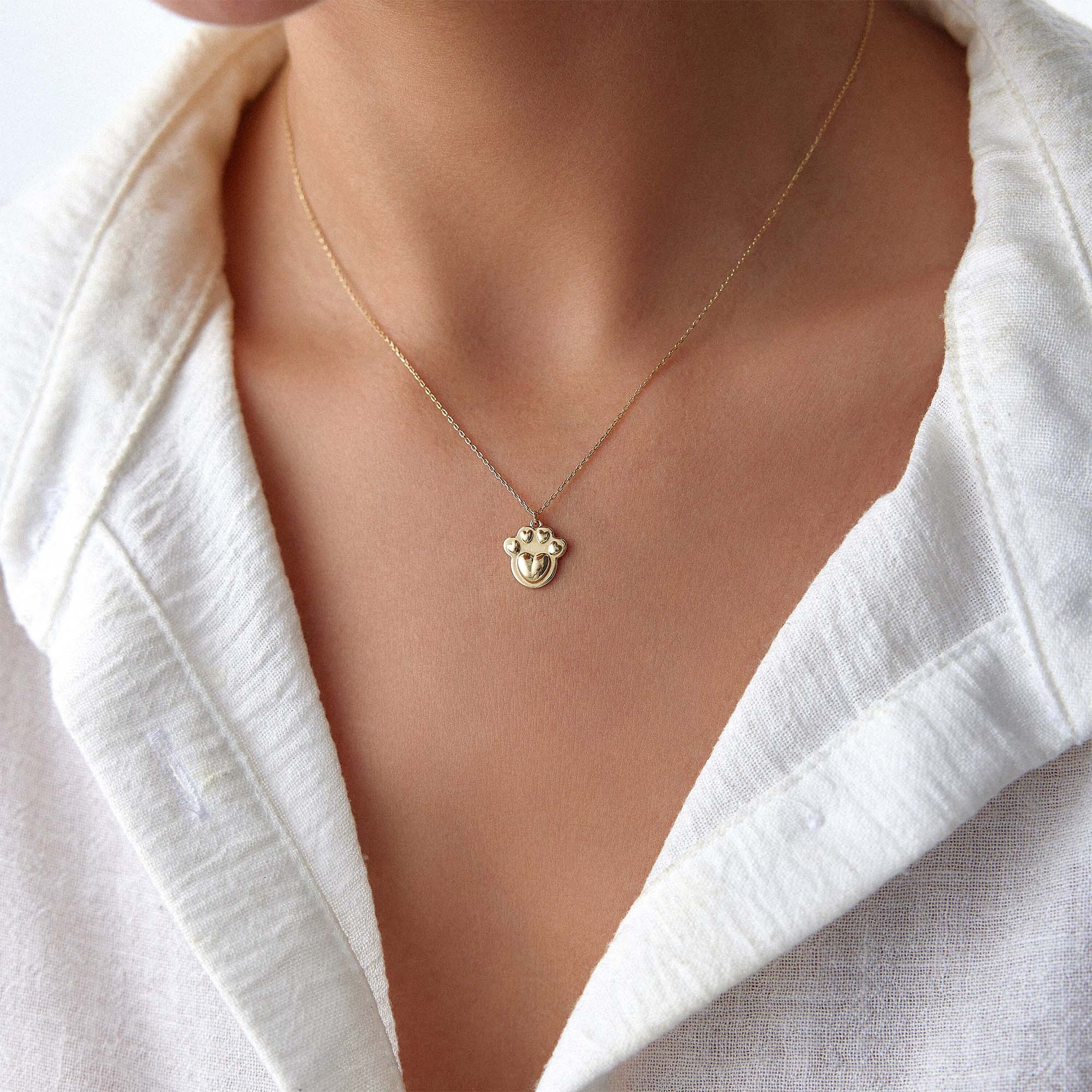 A model wearing a paw necklace