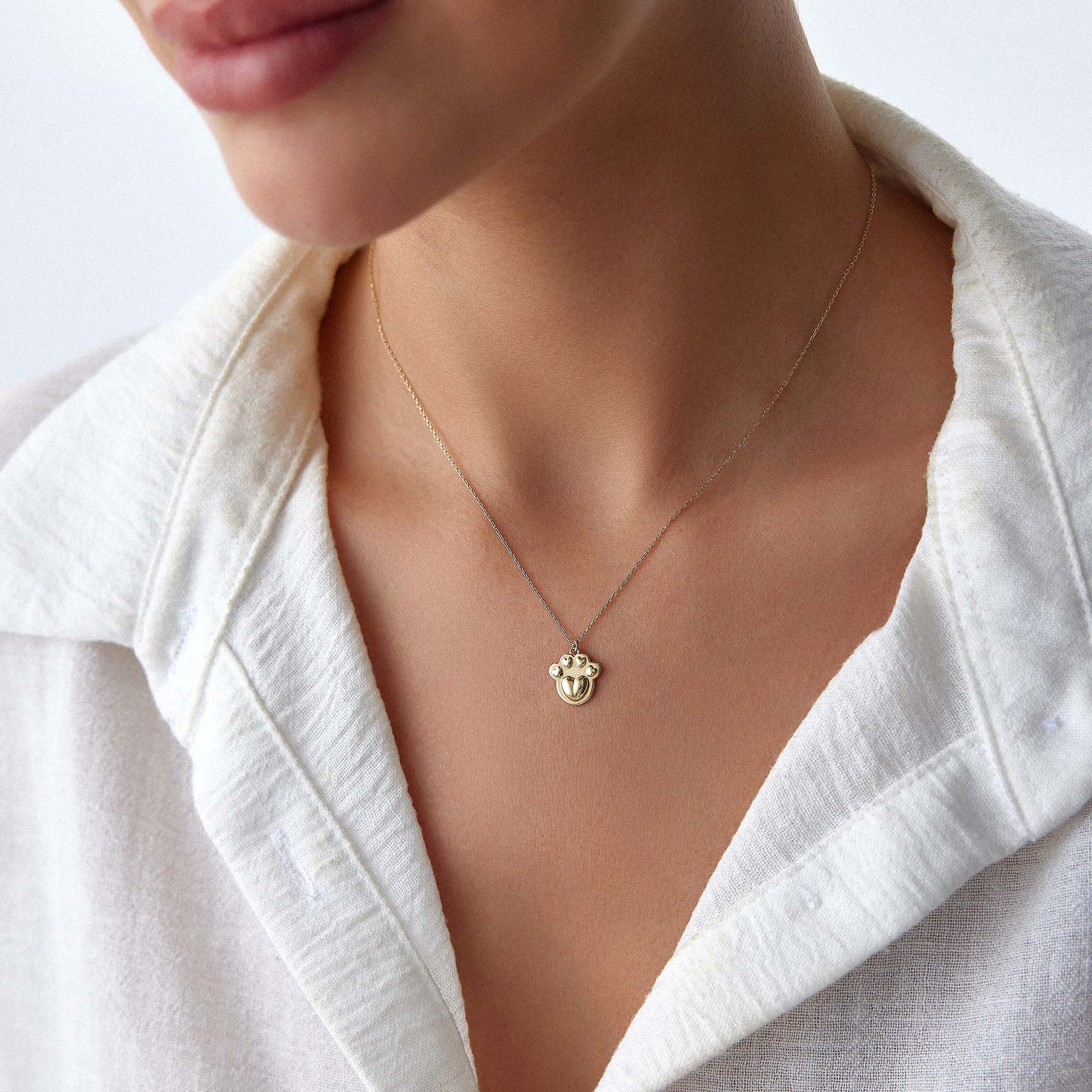 A model wearing a paw necklace