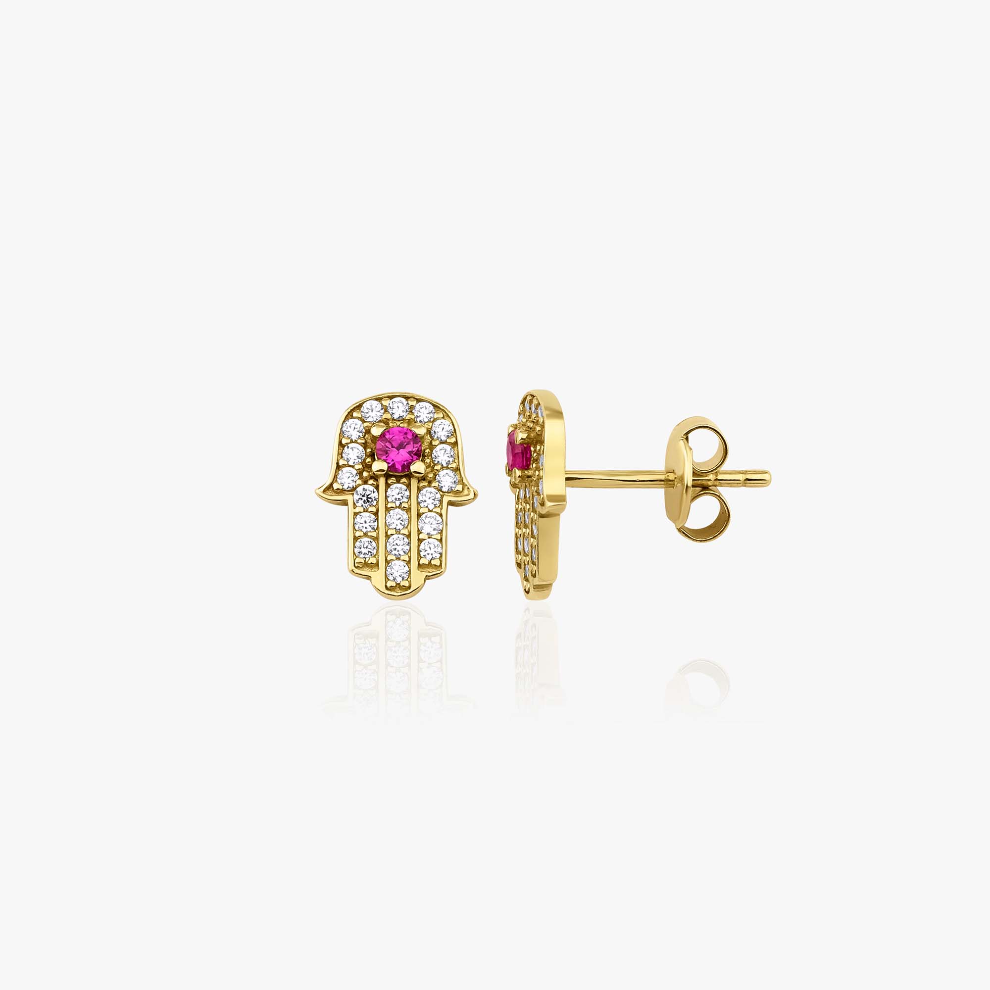 Gold hamsa hand earrings with red gemstones on a white background