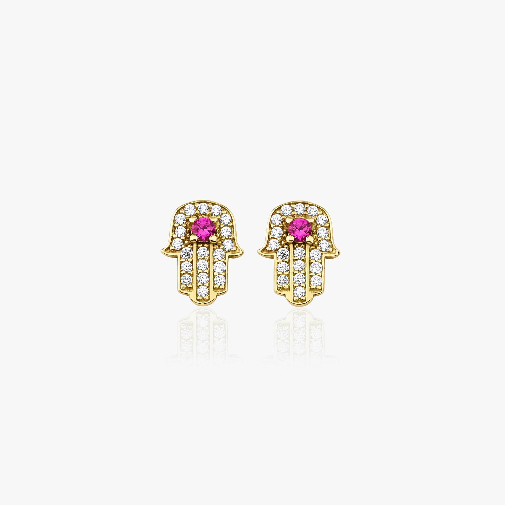 Gold Hamsa hand earrings with red gemstones on a white background