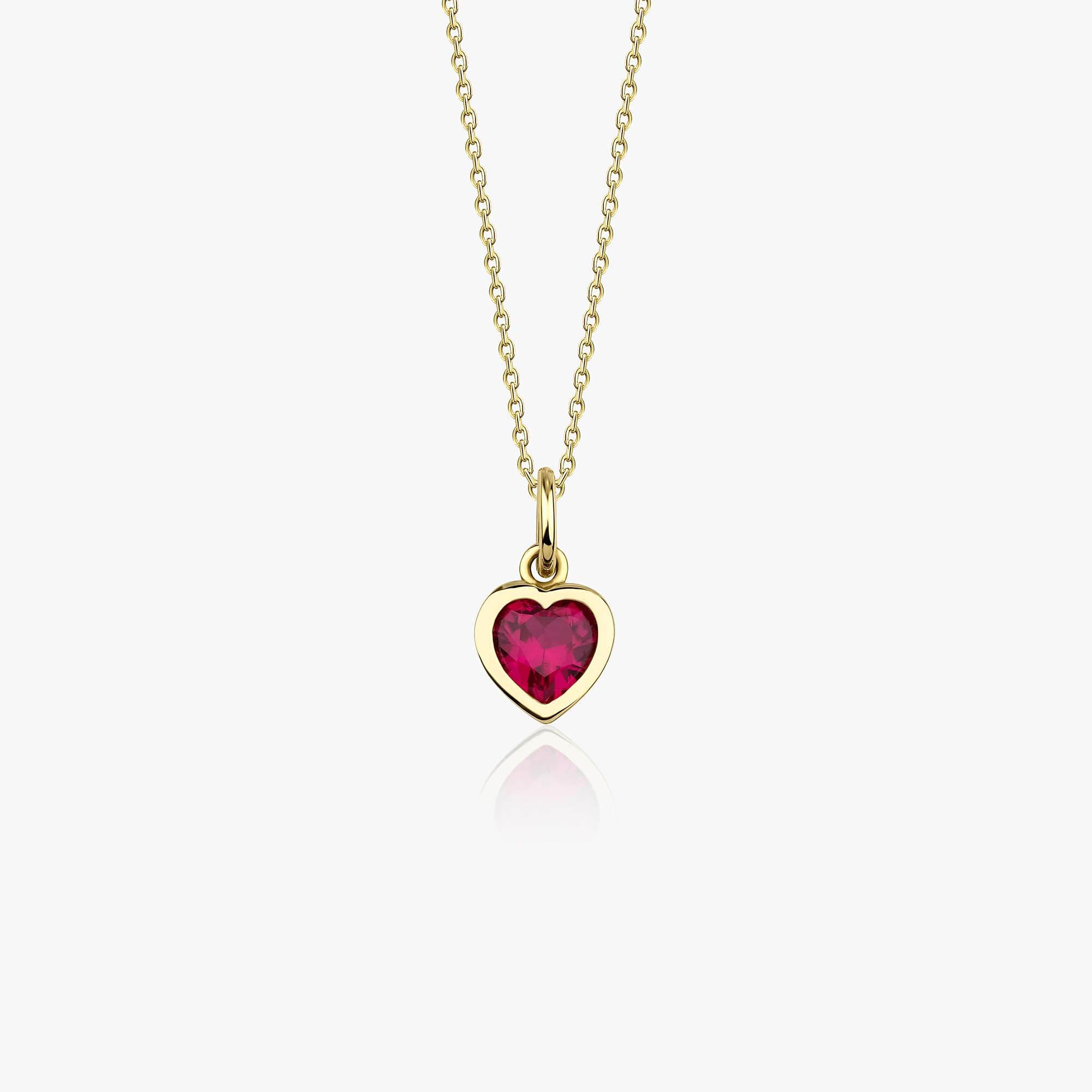 A 14k yellow gold necklace with a heart-shaped red gemstone pendant on a white background