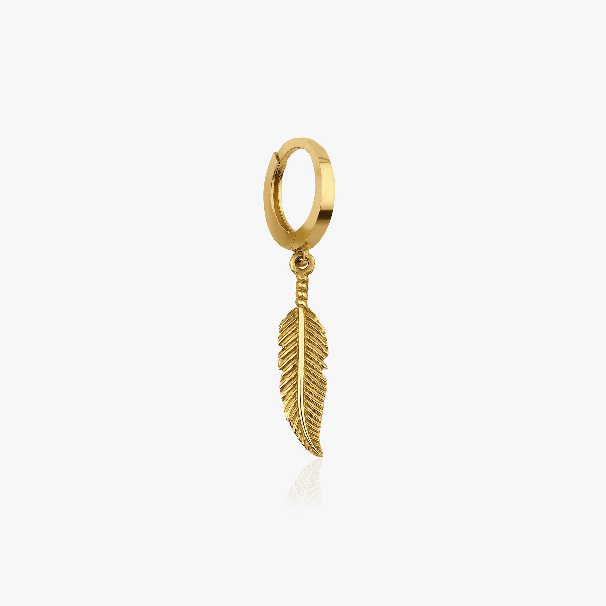 Gold hoop earring with a feather charm on a white background