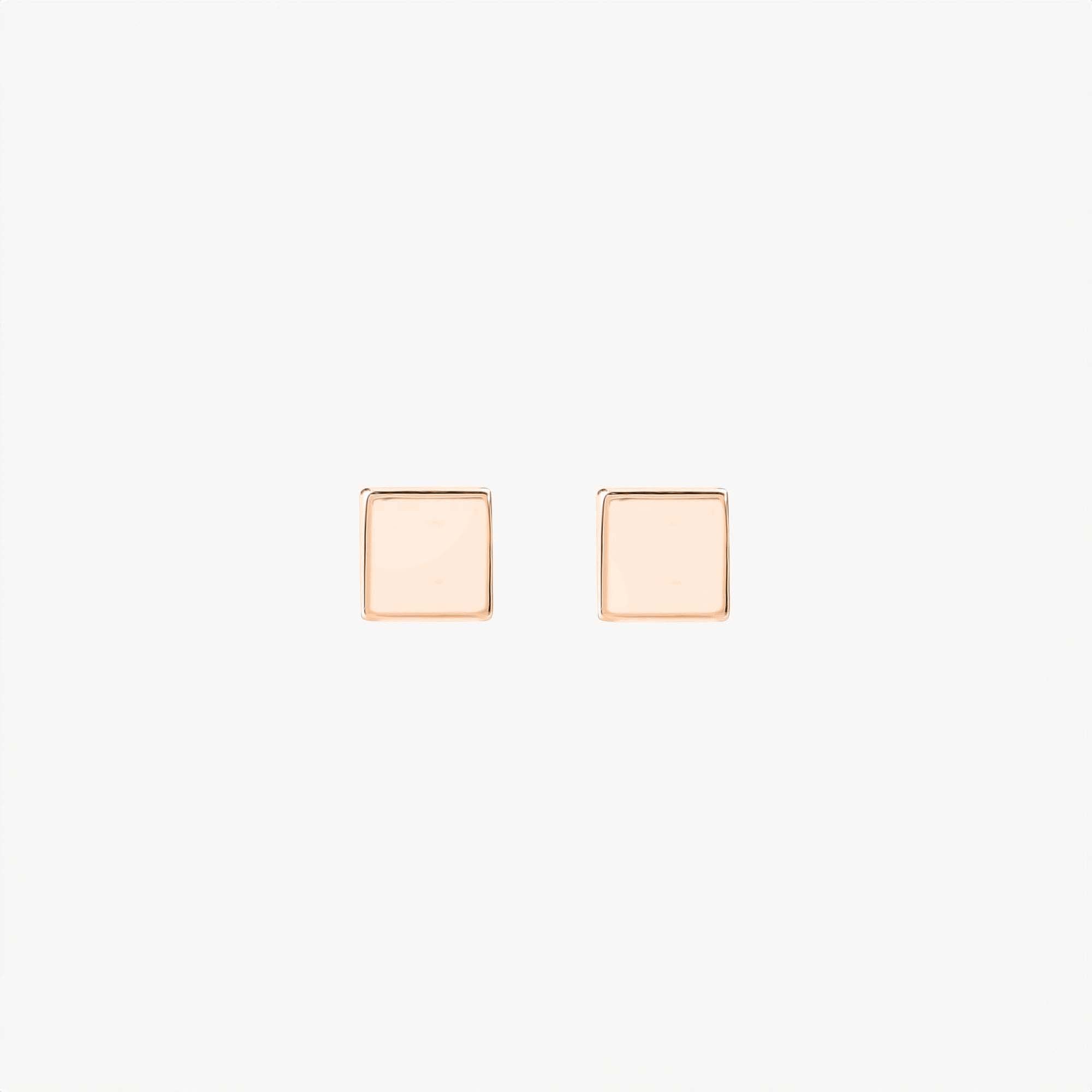 Pair of 14k rose gold square stud earrings on a white background