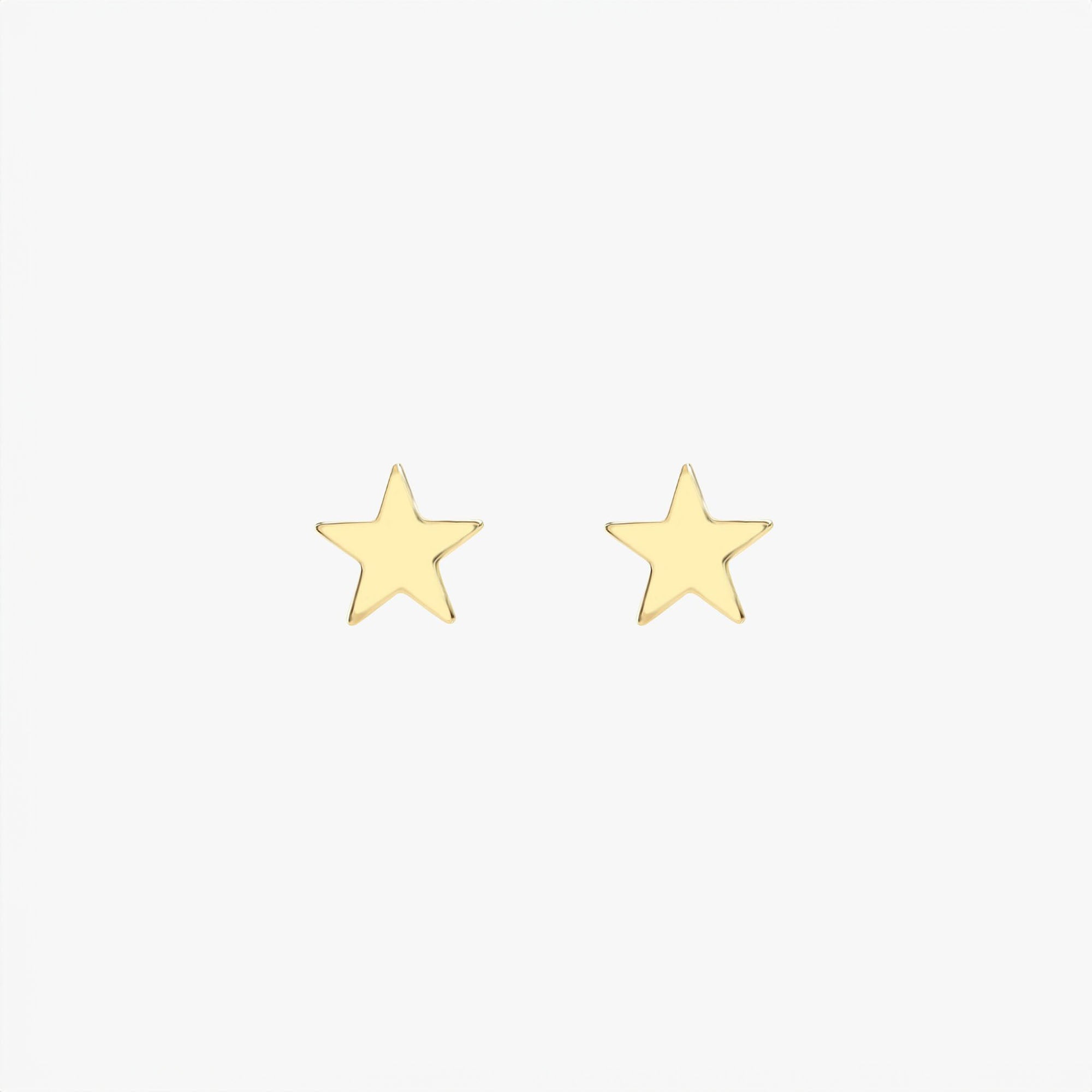 Pair of 14k yellow gold star-shaped earrings on a white background