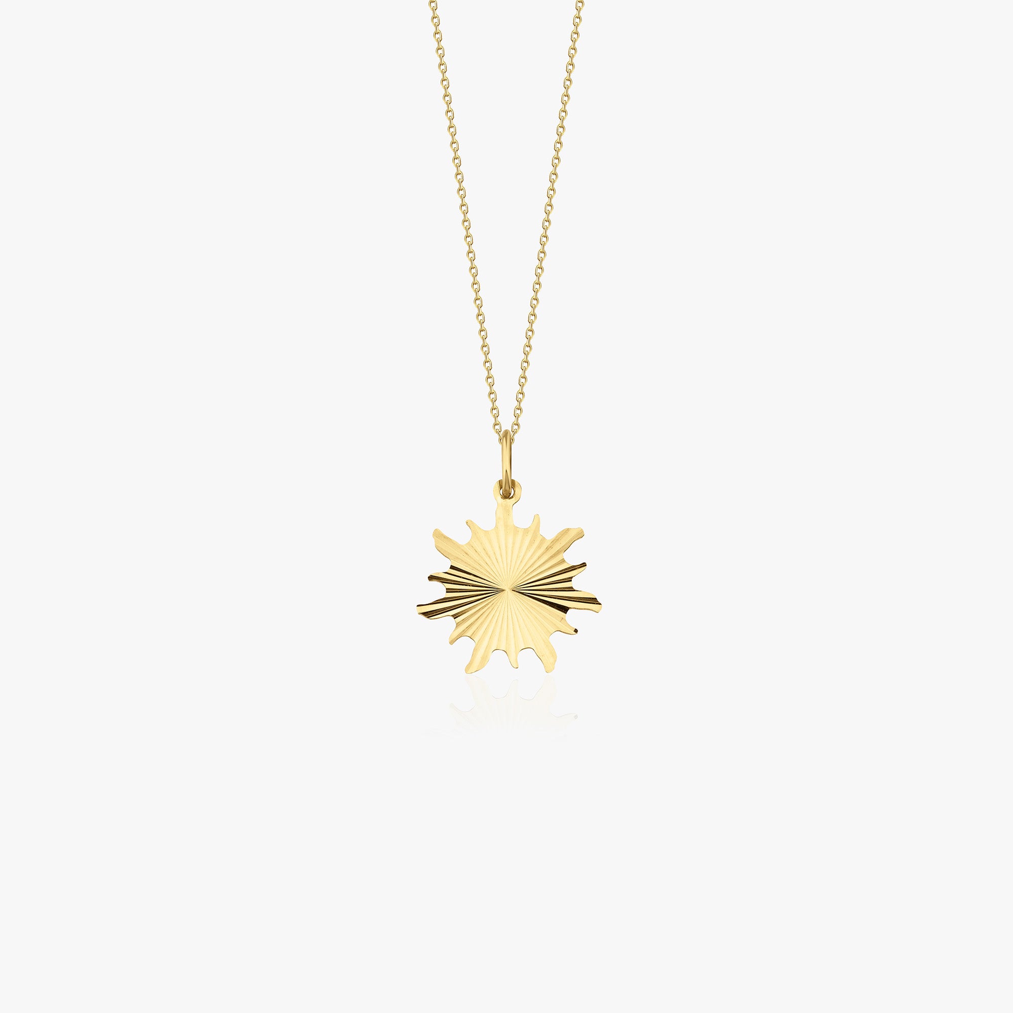 A 14k yellow gold sunburst pendant necklace shown on a white background