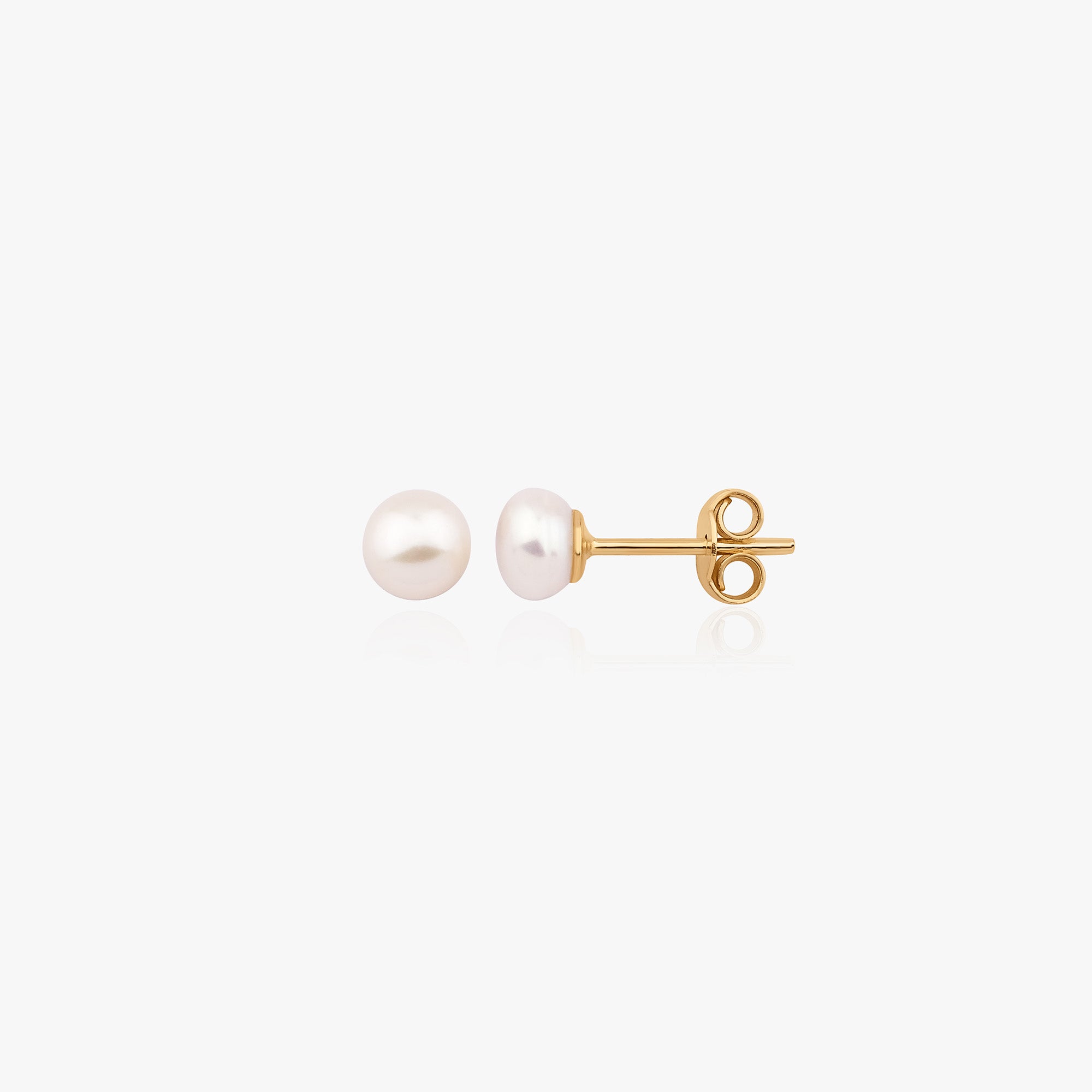 A pair of 14K yellow gold pearl studs shown on a white background.
