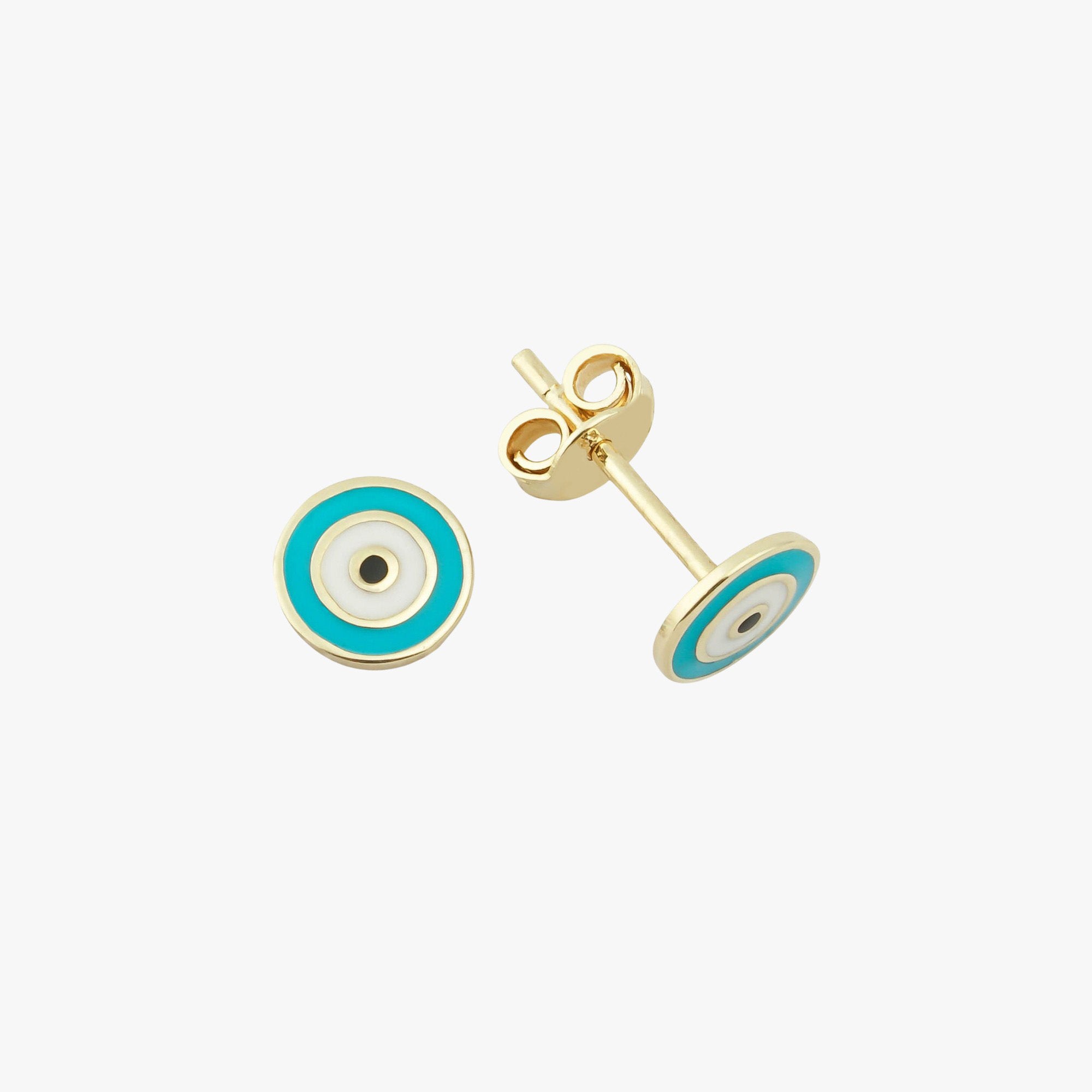 Sideview of a turquoise evil eye stud on a white background.