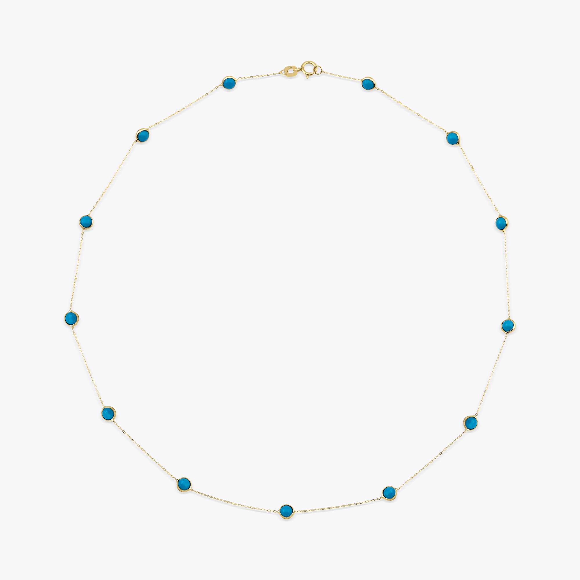 A 14k yellow turquoise station necklace shown on a white background