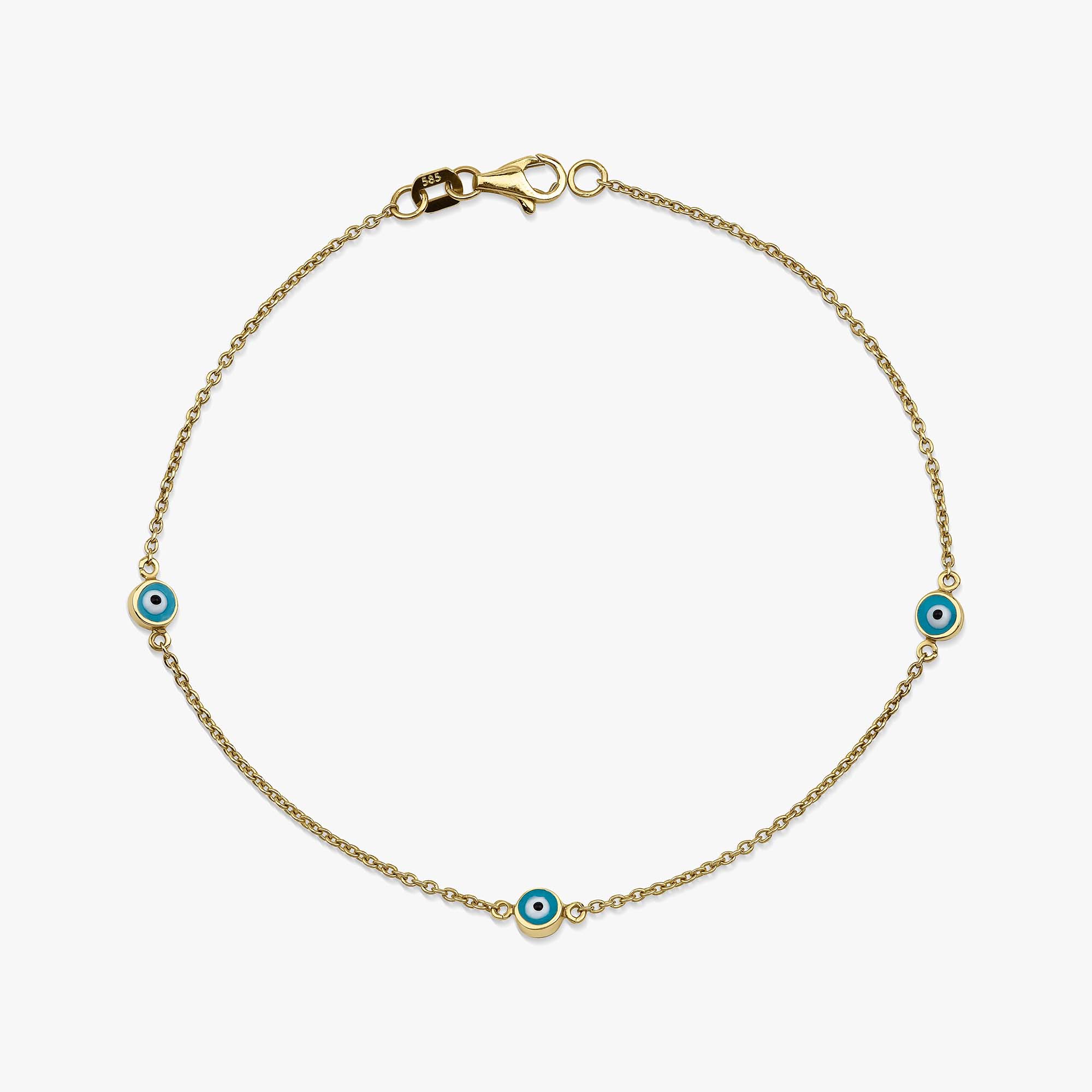 Gold bracelet with blue evil eye charms on a white background