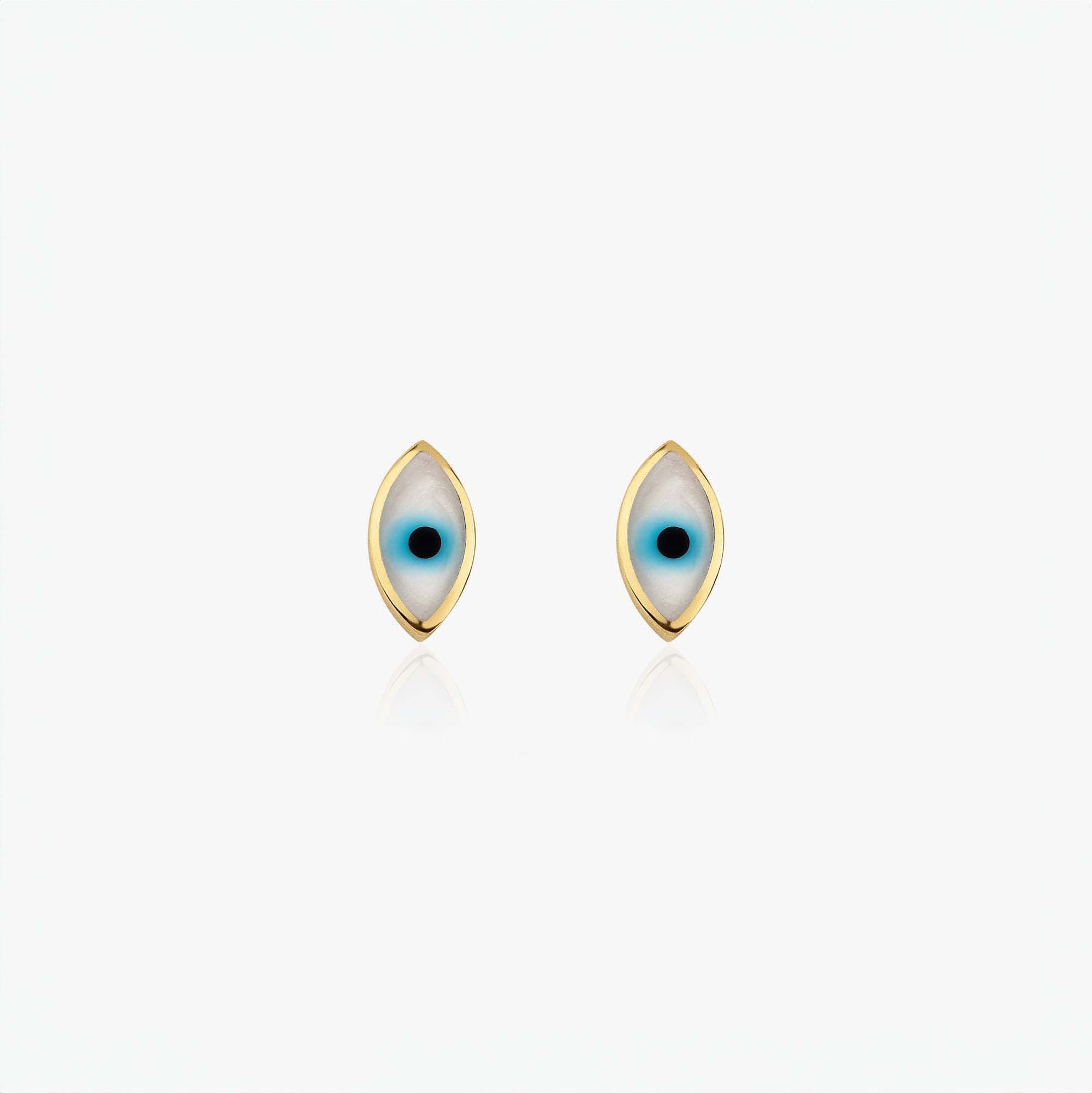 Pair of gold evil eye earrings on a white background