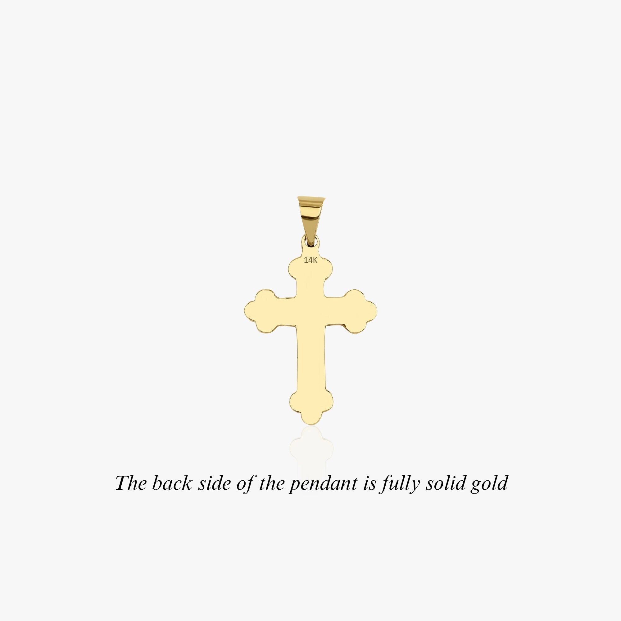 The backside of a large cross pendant with the 14k gold stamp