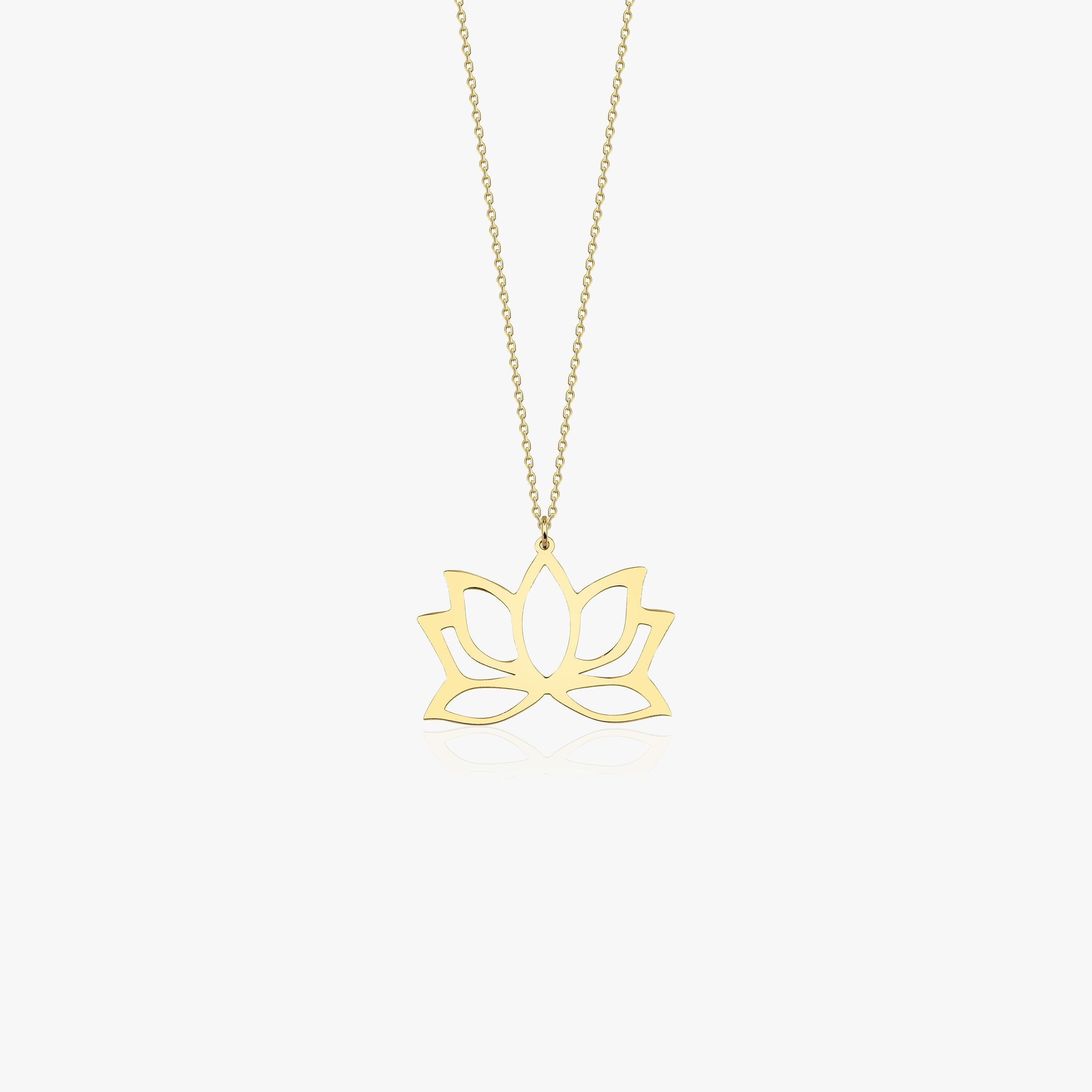 A 14K gold necklace with a large lotus flower pendant.