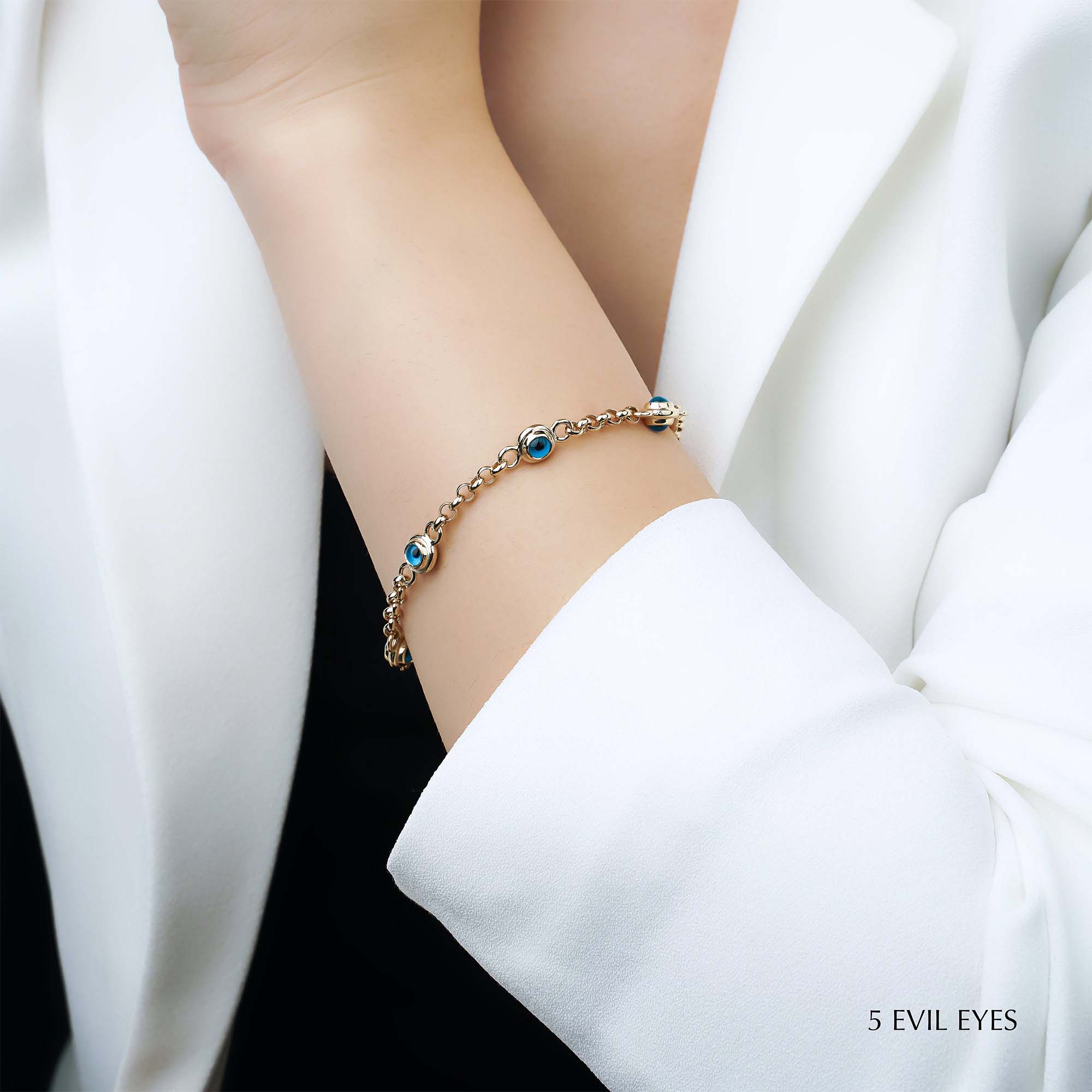 A 14K gold bracelet featuring a rolo chain design with five blue evil eye charms.