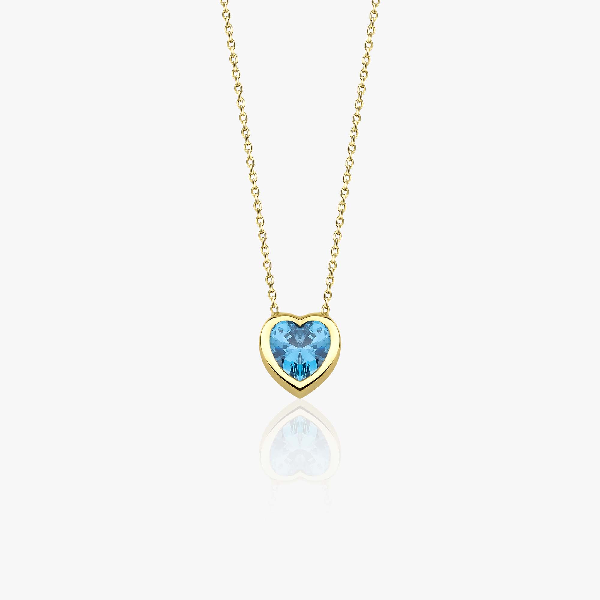 A 14k yellow gold necklace with a heart-shaped blue gemstone pendant on a white background