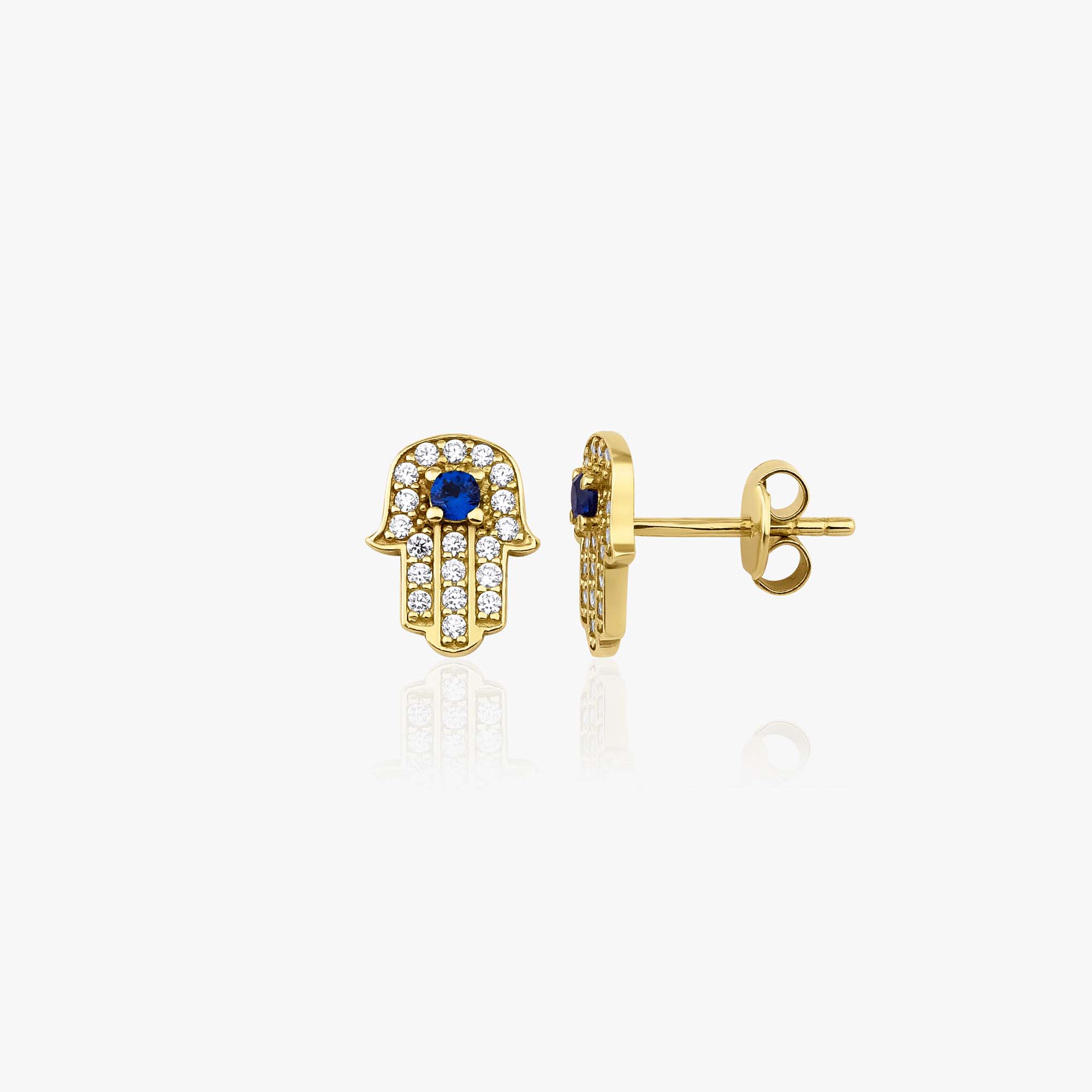 Gold hamsa hand earrings with blue stones on a white background