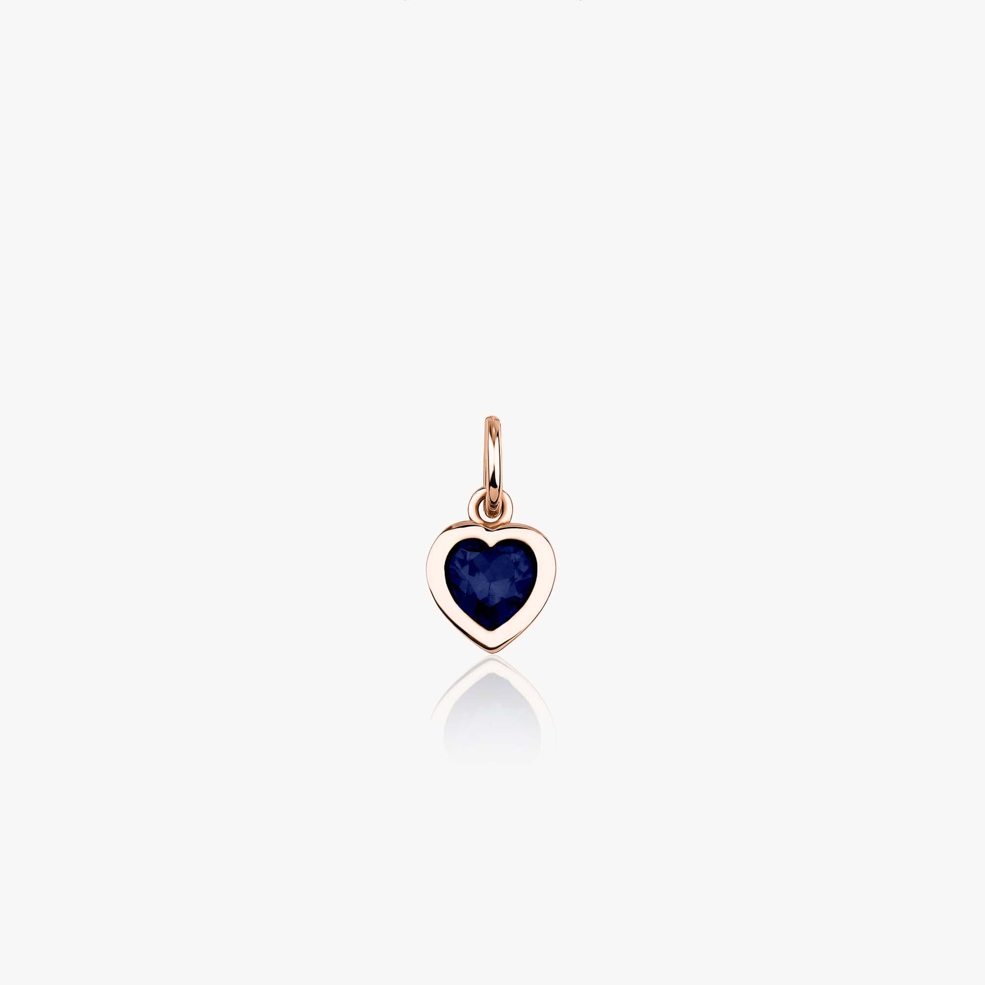 A 14k rose gold heart-shaped pendant with a blue stone on a white background