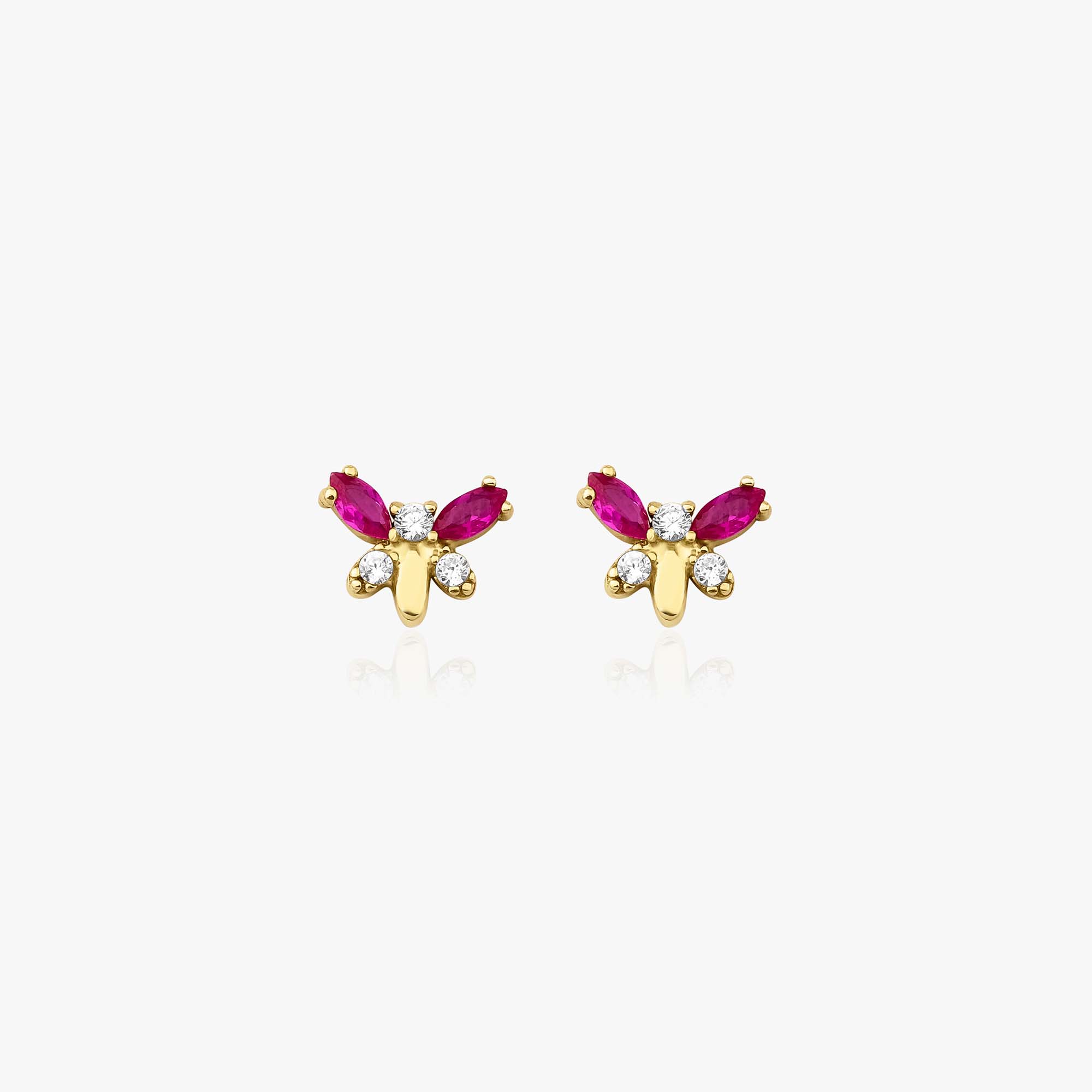 Butterfly-shaped earrings with red gemstones and gold accents on a white background