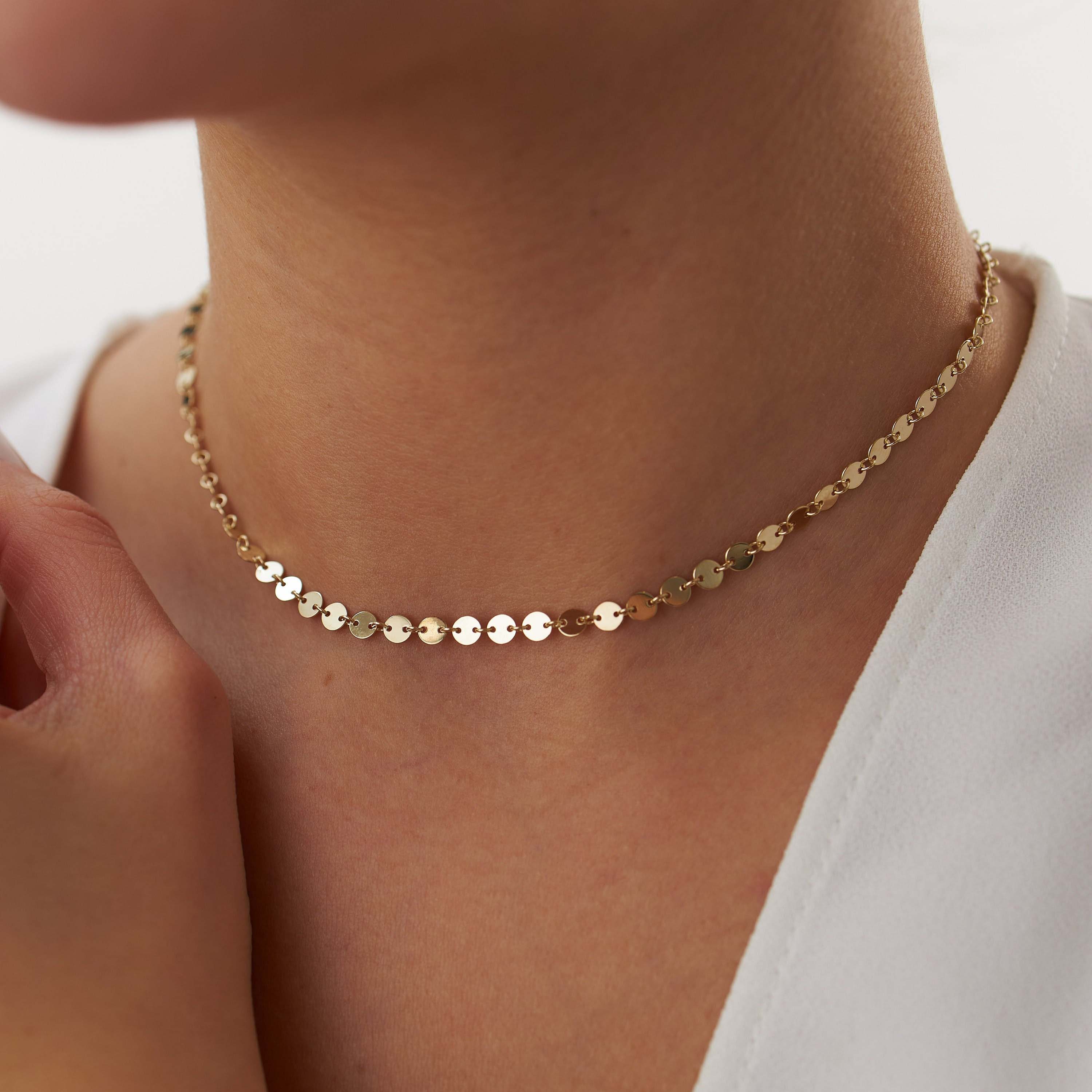 14k yellow gold circle chain necklace worn by a person with a plain background