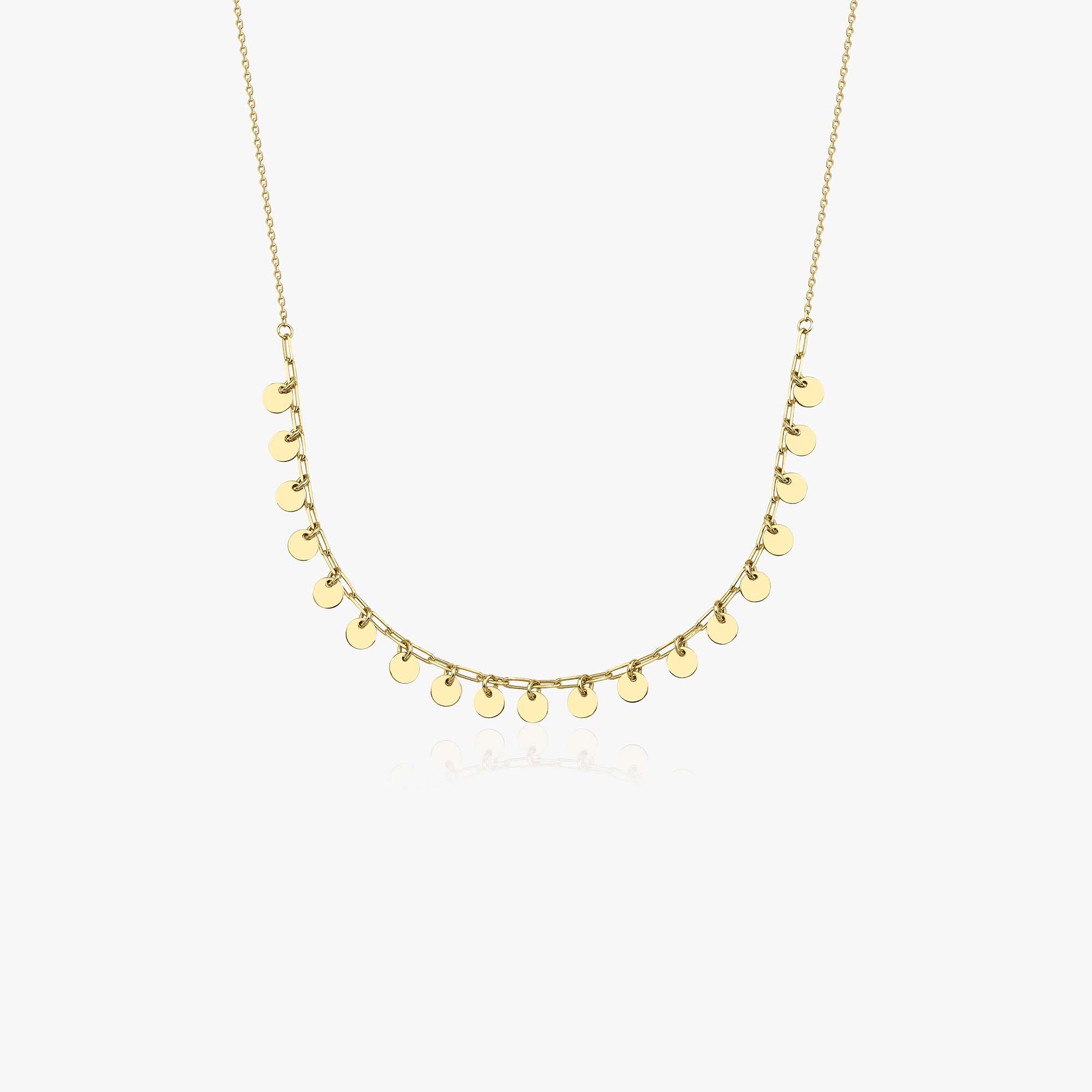 A 14k yellow gold layering disc necklace shown in white gold