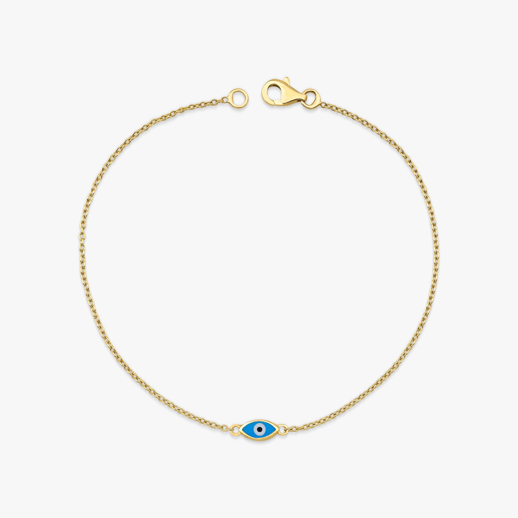 Gold bracelet with an elongated blue evil eye charm on a white background