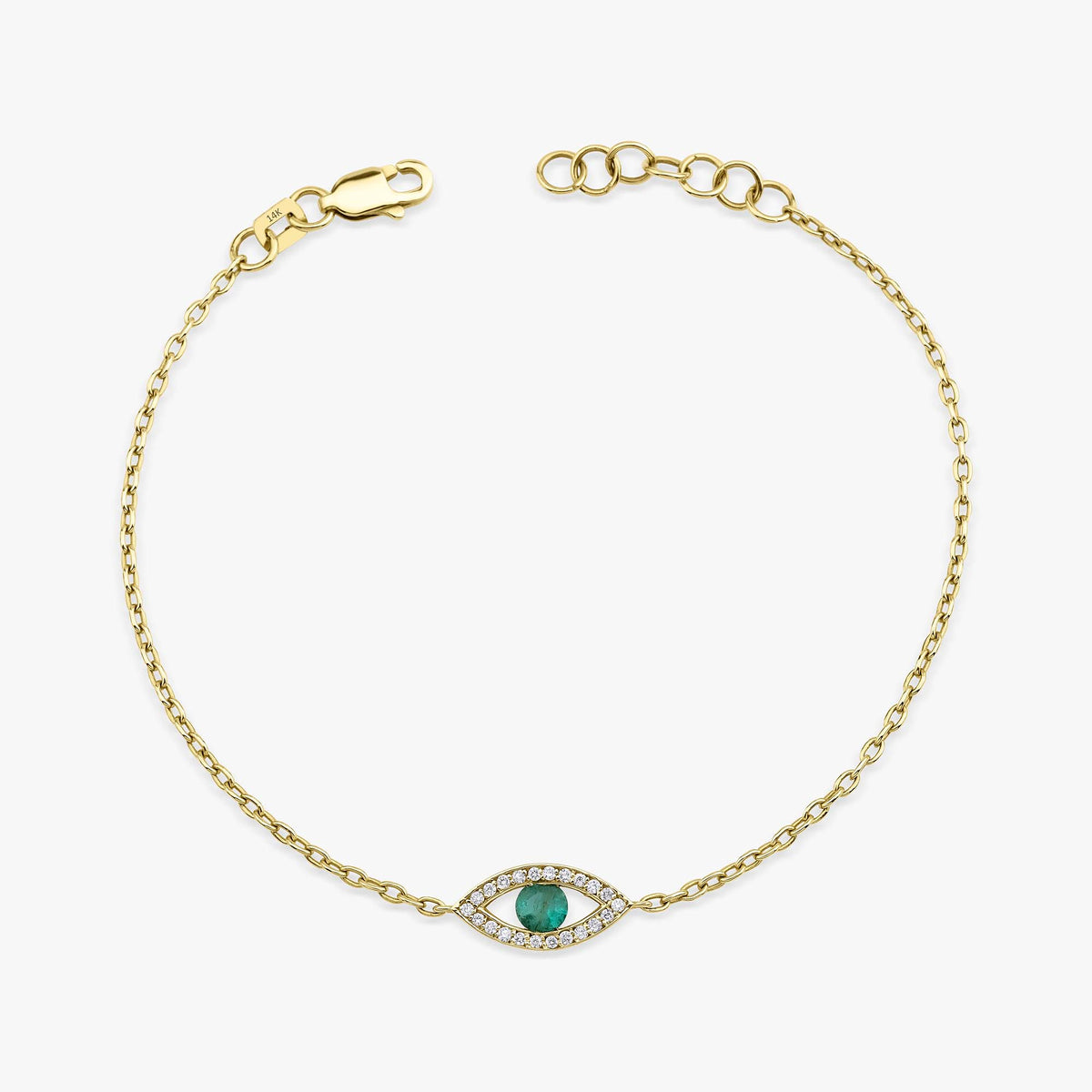 A delicate gold chain bracelet with a central evil eye charm featuring a green emerald surrounded by small clear diamonds, displayed on a clean white background.