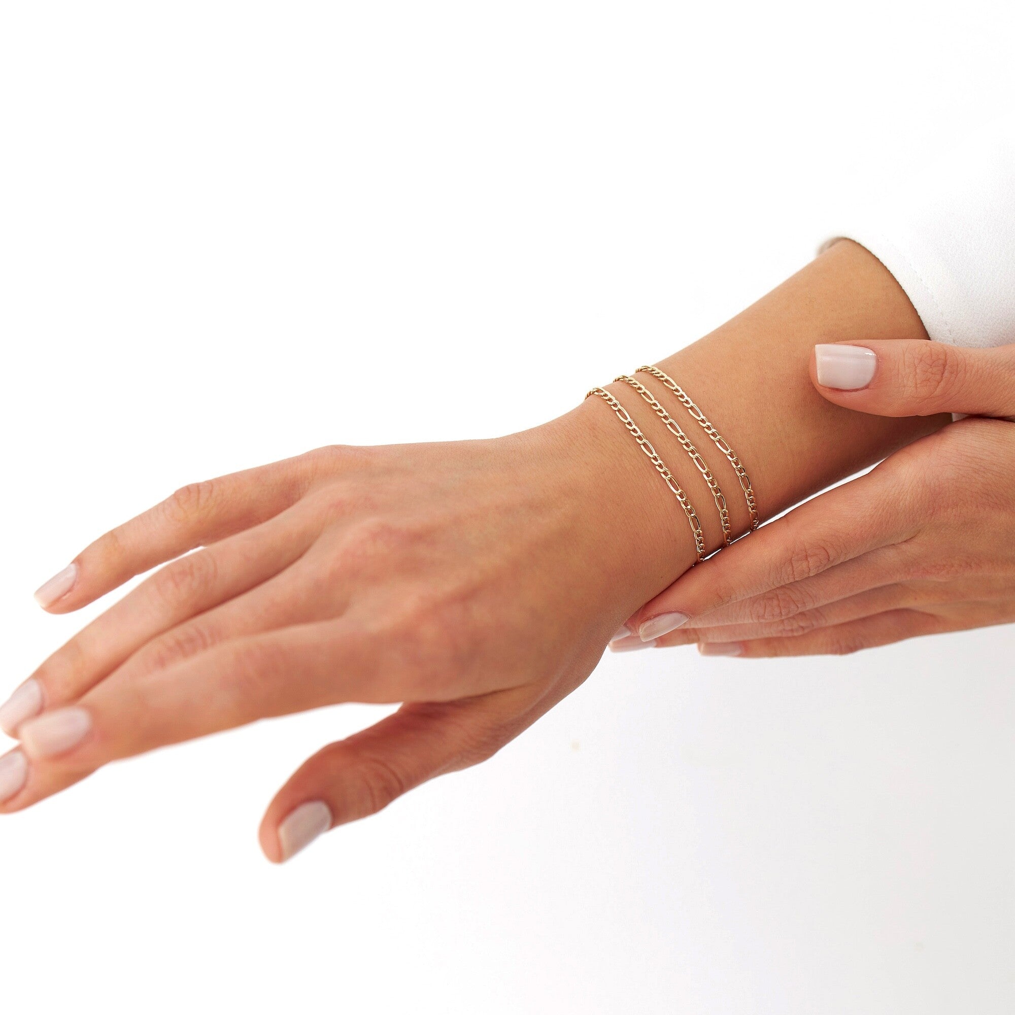 3 figaro chain bracelets on a models wrist