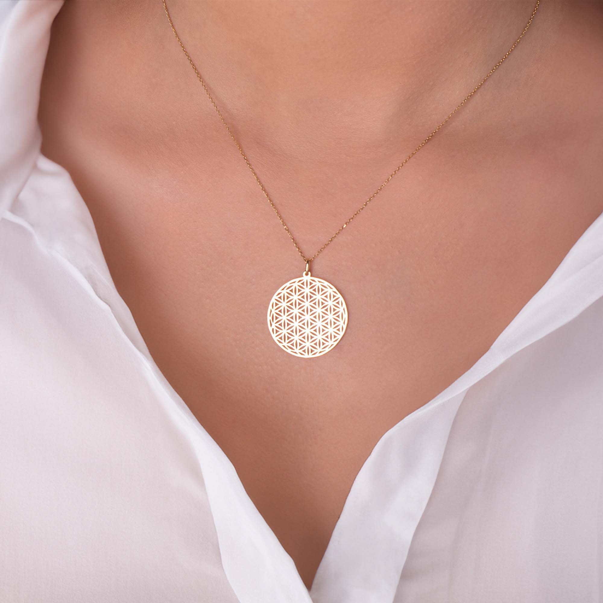 A model wearing a Flower Of Life Pendant on a thin gold chain